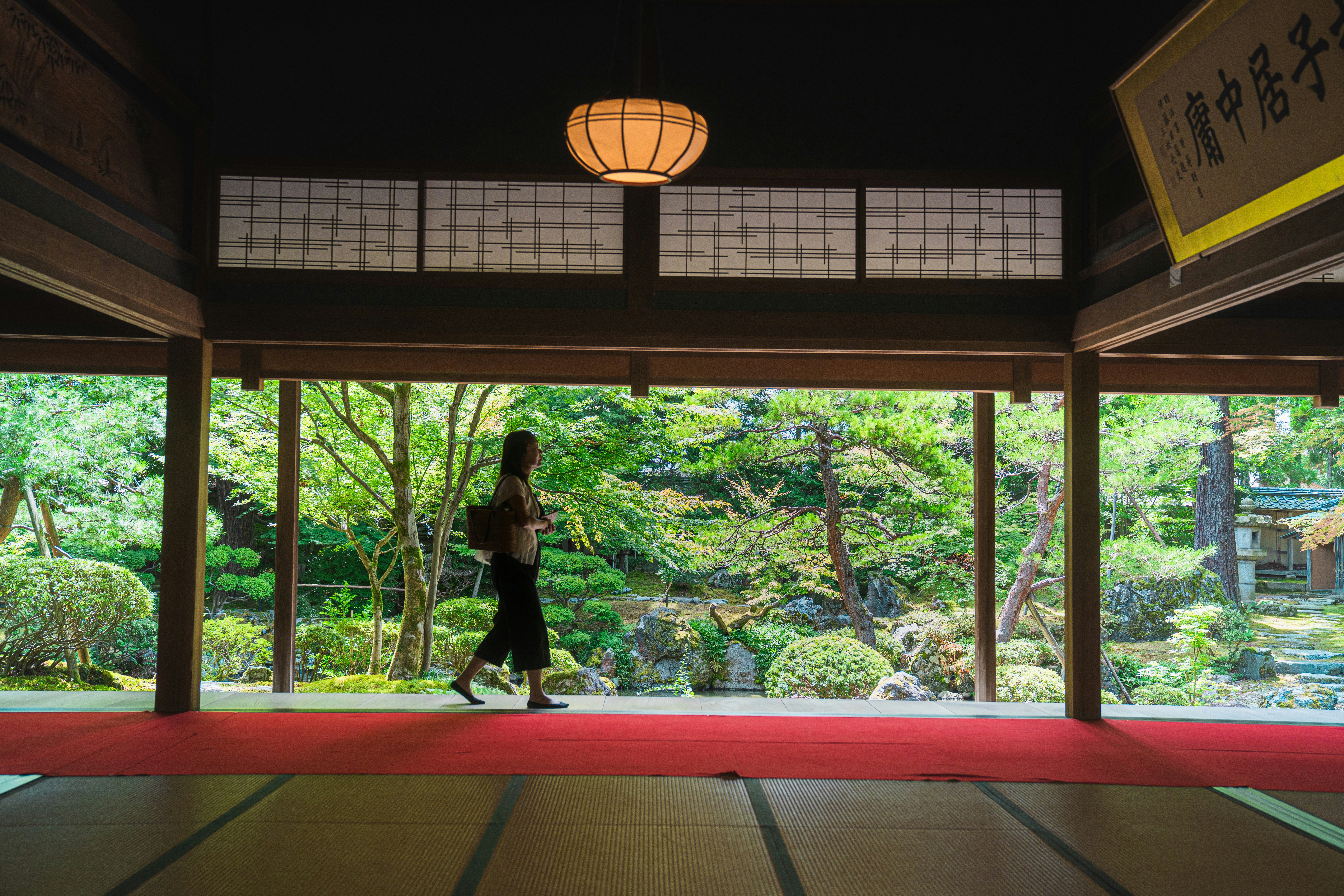 庭園の縁側から眺める緑と石の景色
