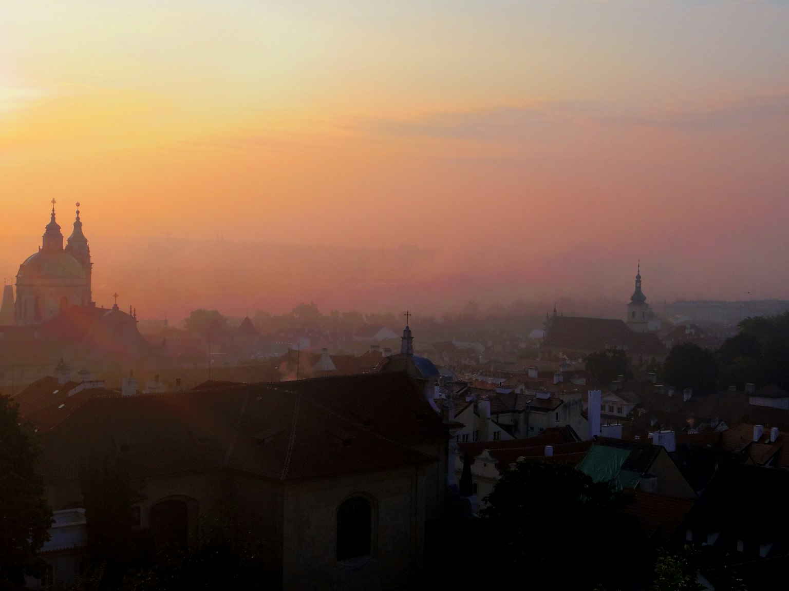 Beautiful cityscape at dusk with silhouettes of churches