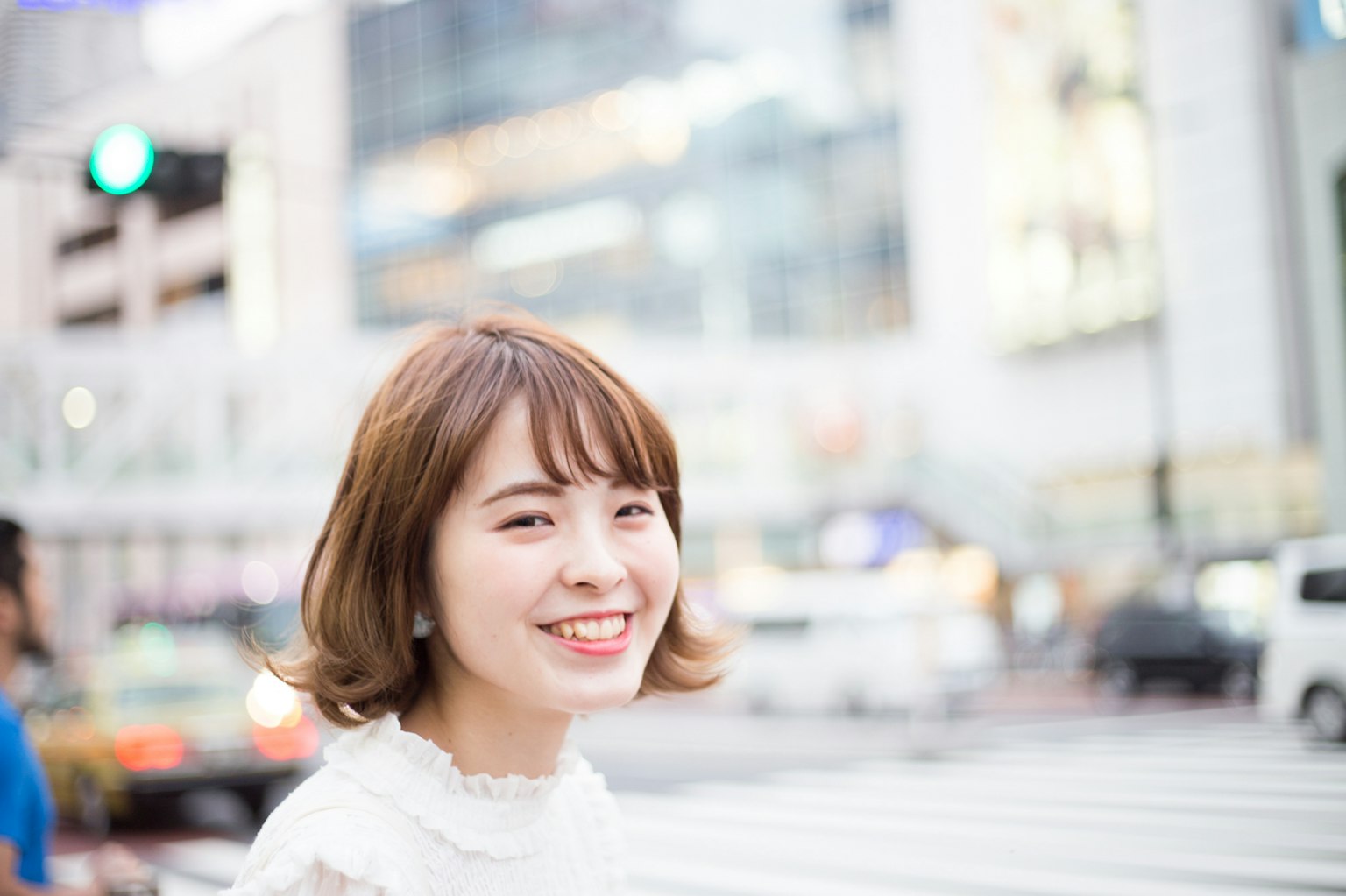 Young woman smiling in the city with a blurred urban background