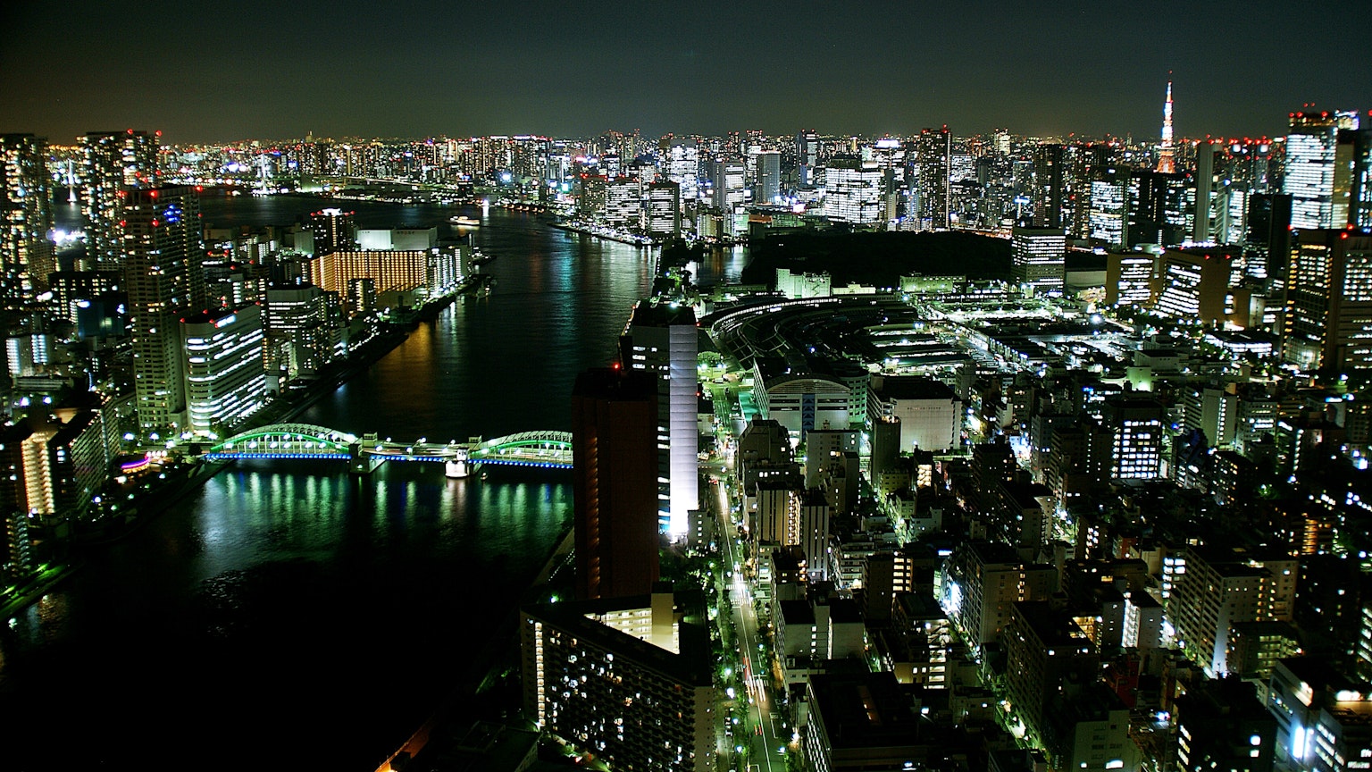 Tokyo night view with illuminated river and skyscrapers