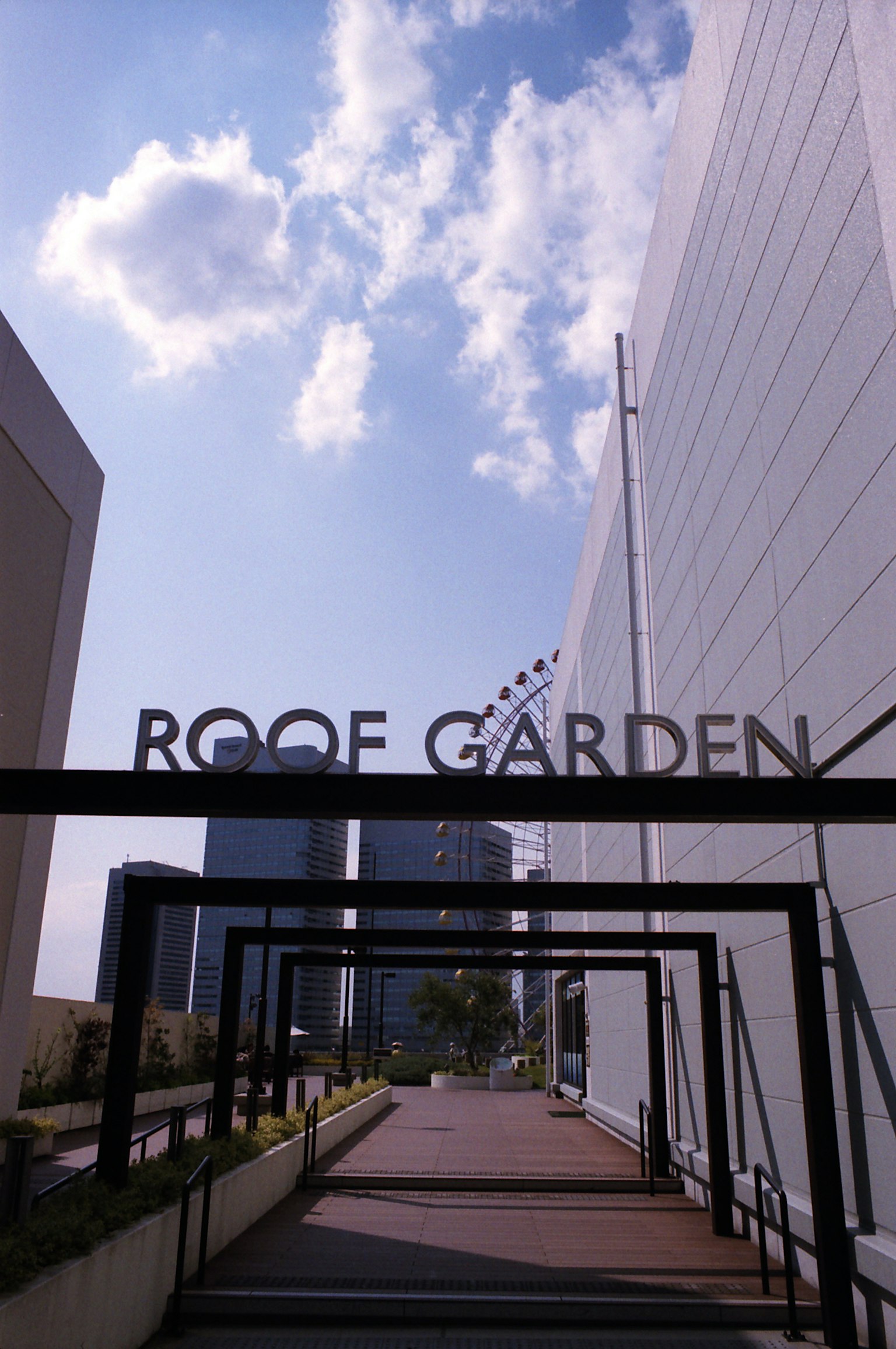 Sign for Roof Garden with blue sky and white clouds
