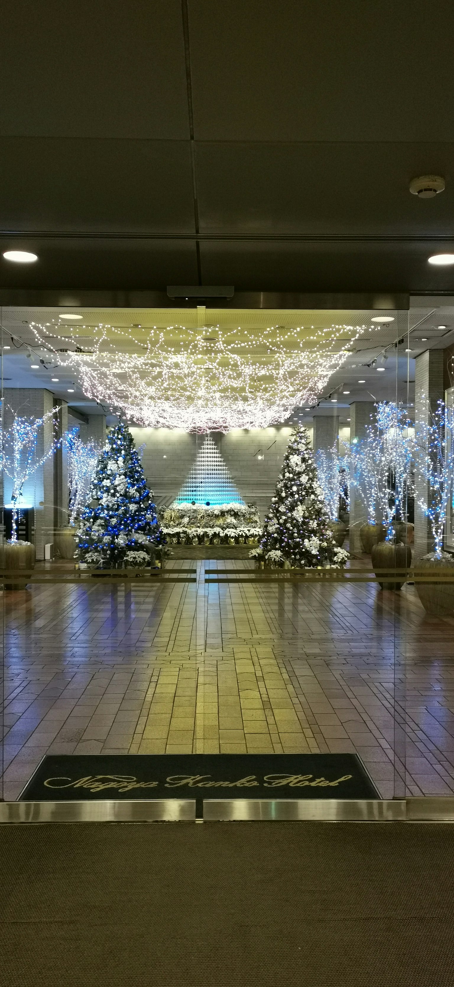 Eingang zu einem wunderschön dekorierten Saal für Weihnachten mit Bäumen und Lichtern