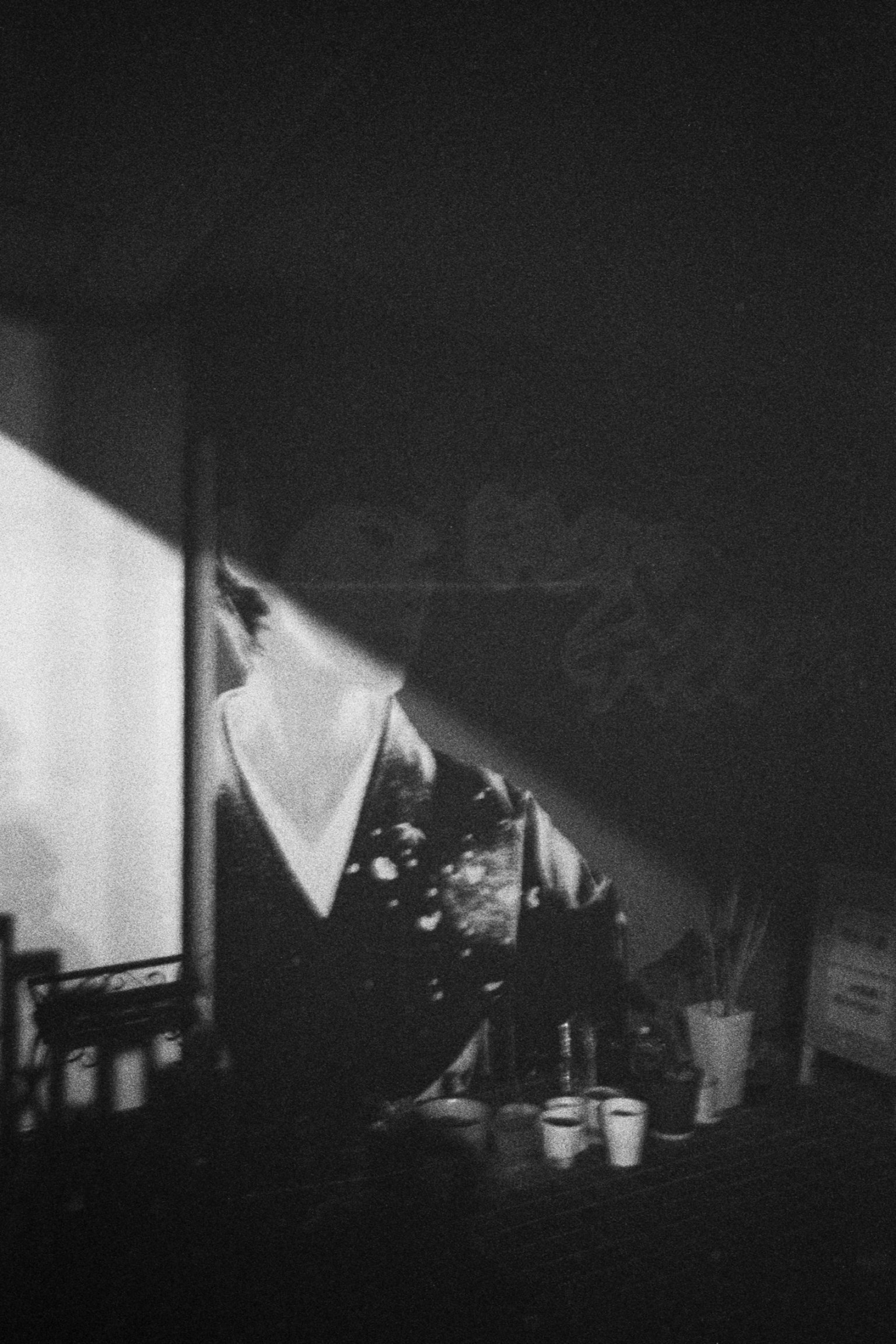 Monochrome photo featuring a silhouette of a person with diagonal light and shadows
