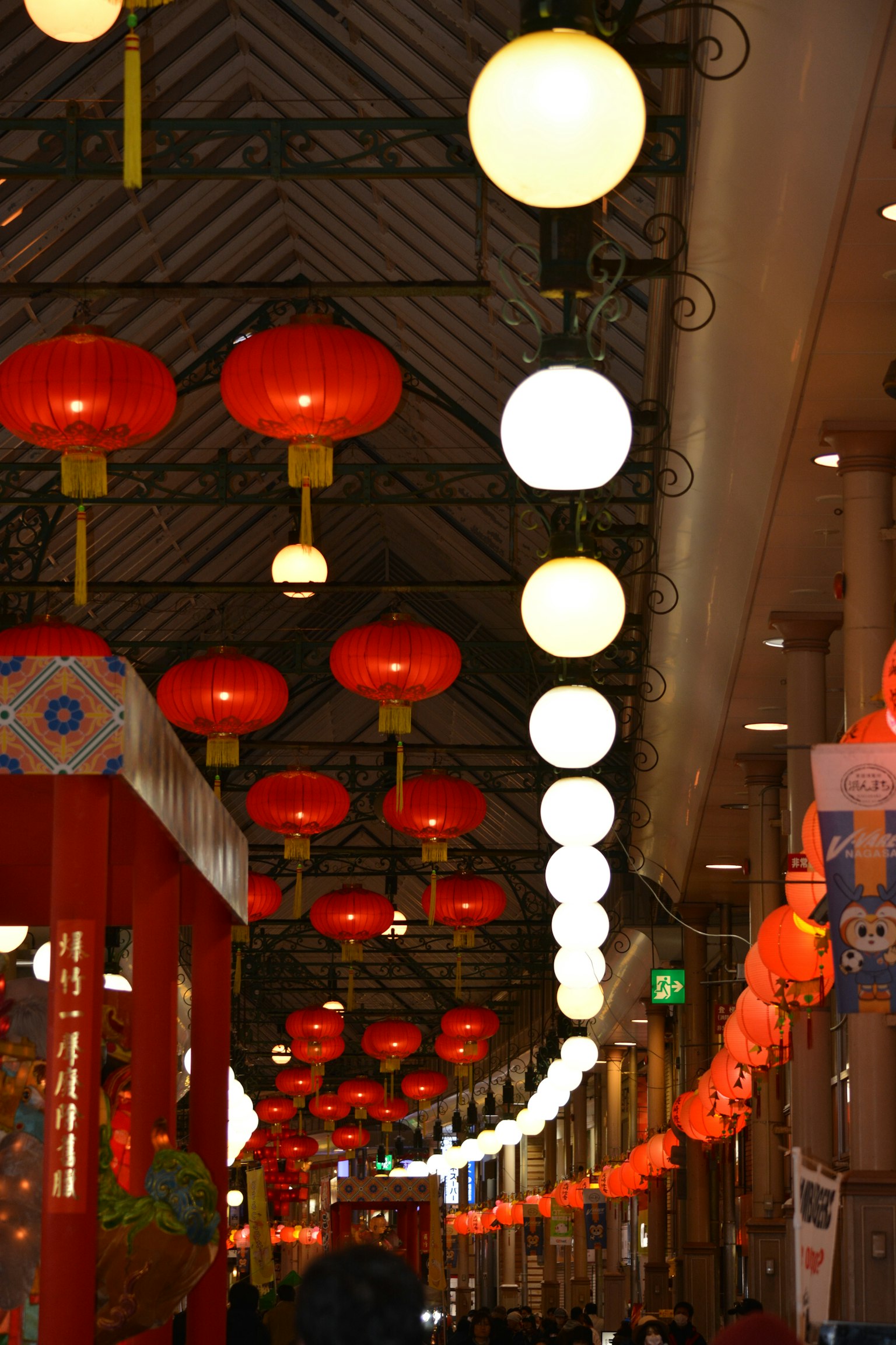 Vibrant interior of a street adorned with red lanterns and white lights