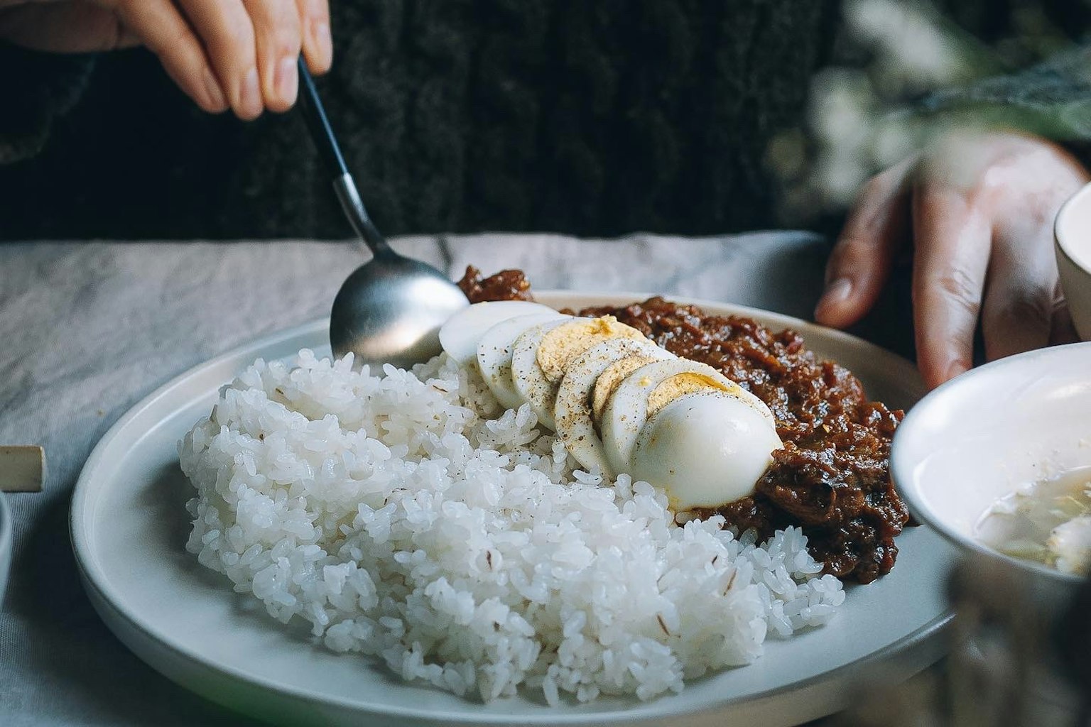 Plate of rice topped with meat and banana slices
