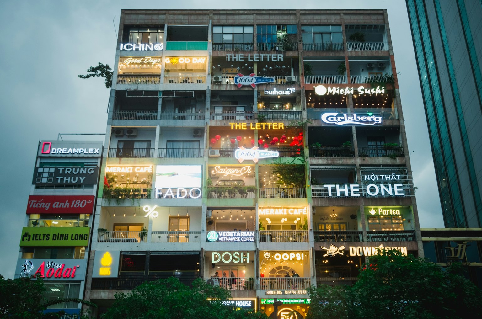 Facade of a building displaying numerous colorful signs
