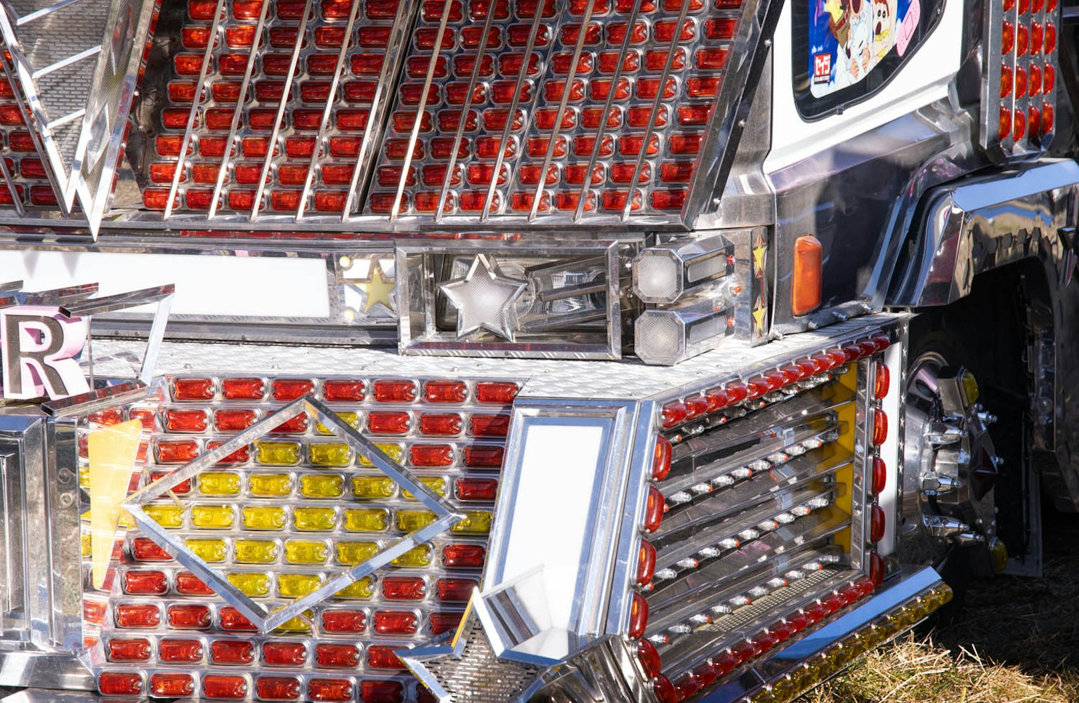 Decorated truck front with shiny red and yellow embellishments metallic details