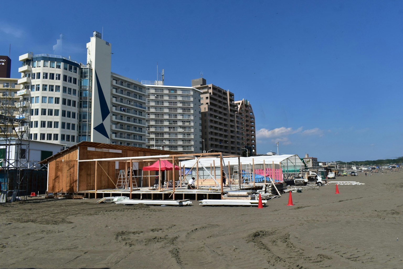 Beach scene with a construction site and tall buildings