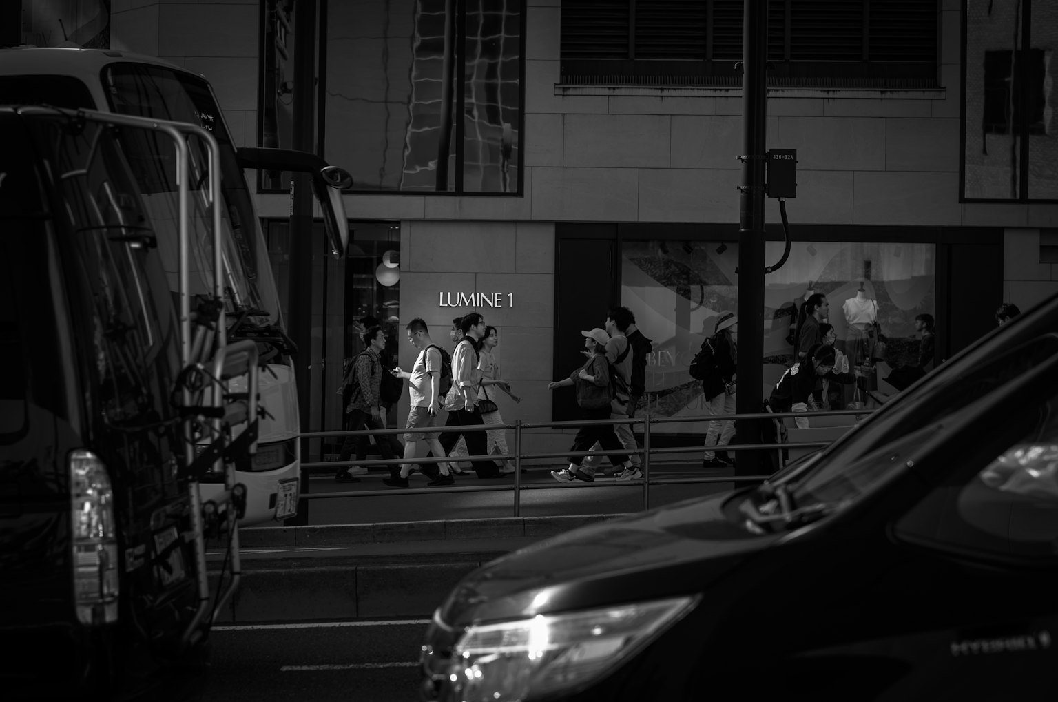 Black and white urban scene with people walking on the street