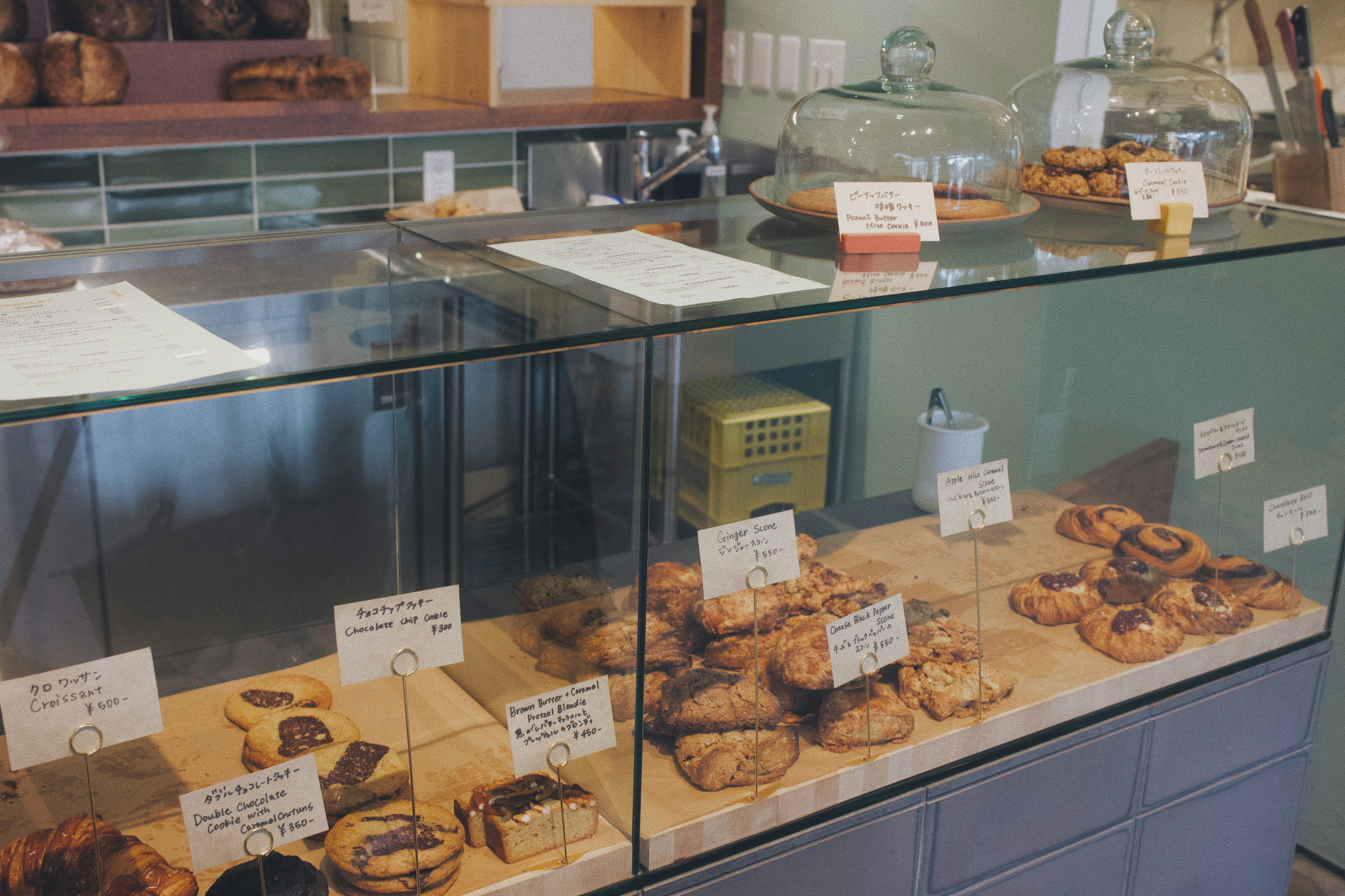 pastry display behind a glass case with assorted cookies and cakes
