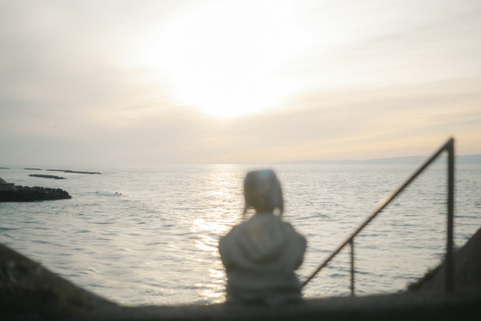 Donna che guarda il tramonto vista costiera serena e mare calmo