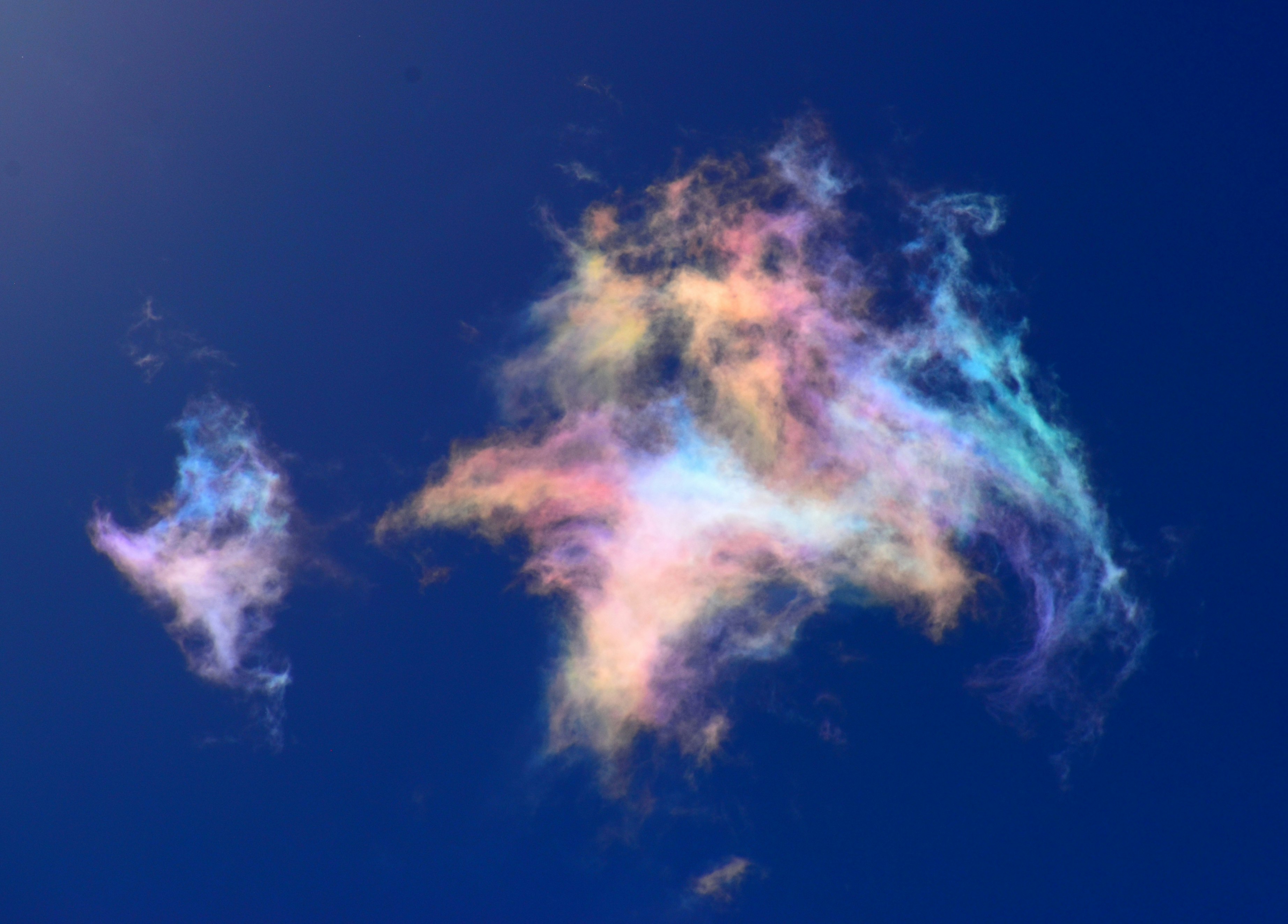 青空に浮かぶ彩雲のような虹色の雲