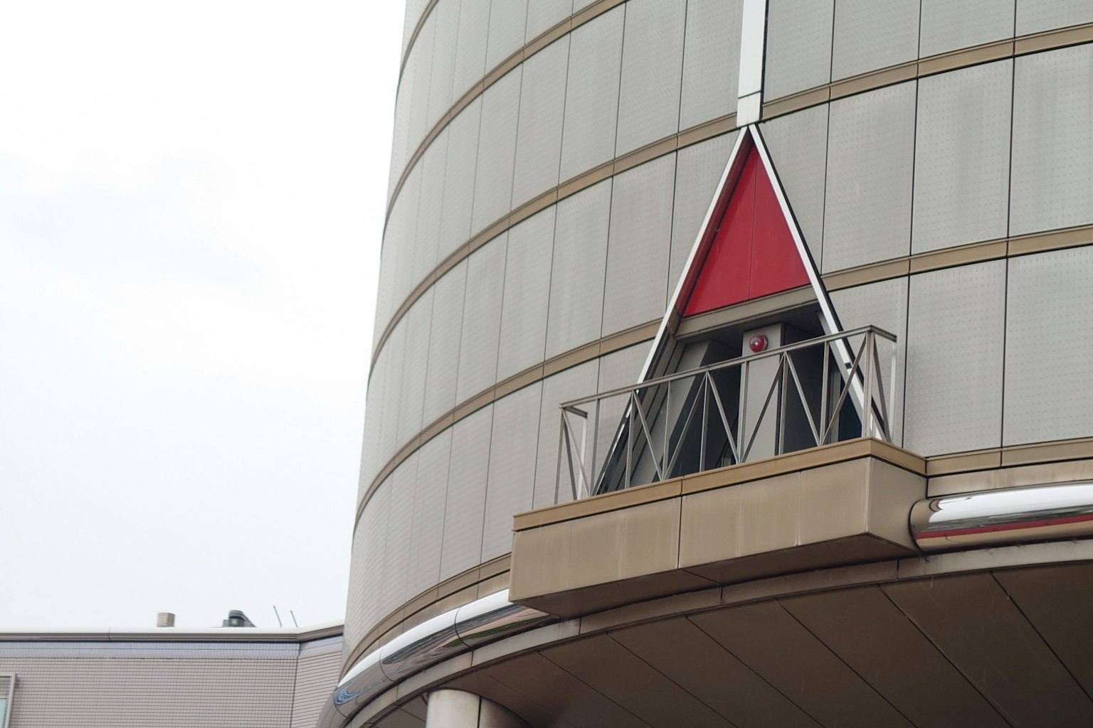 Part of a building featuring a distinctive red triangular design