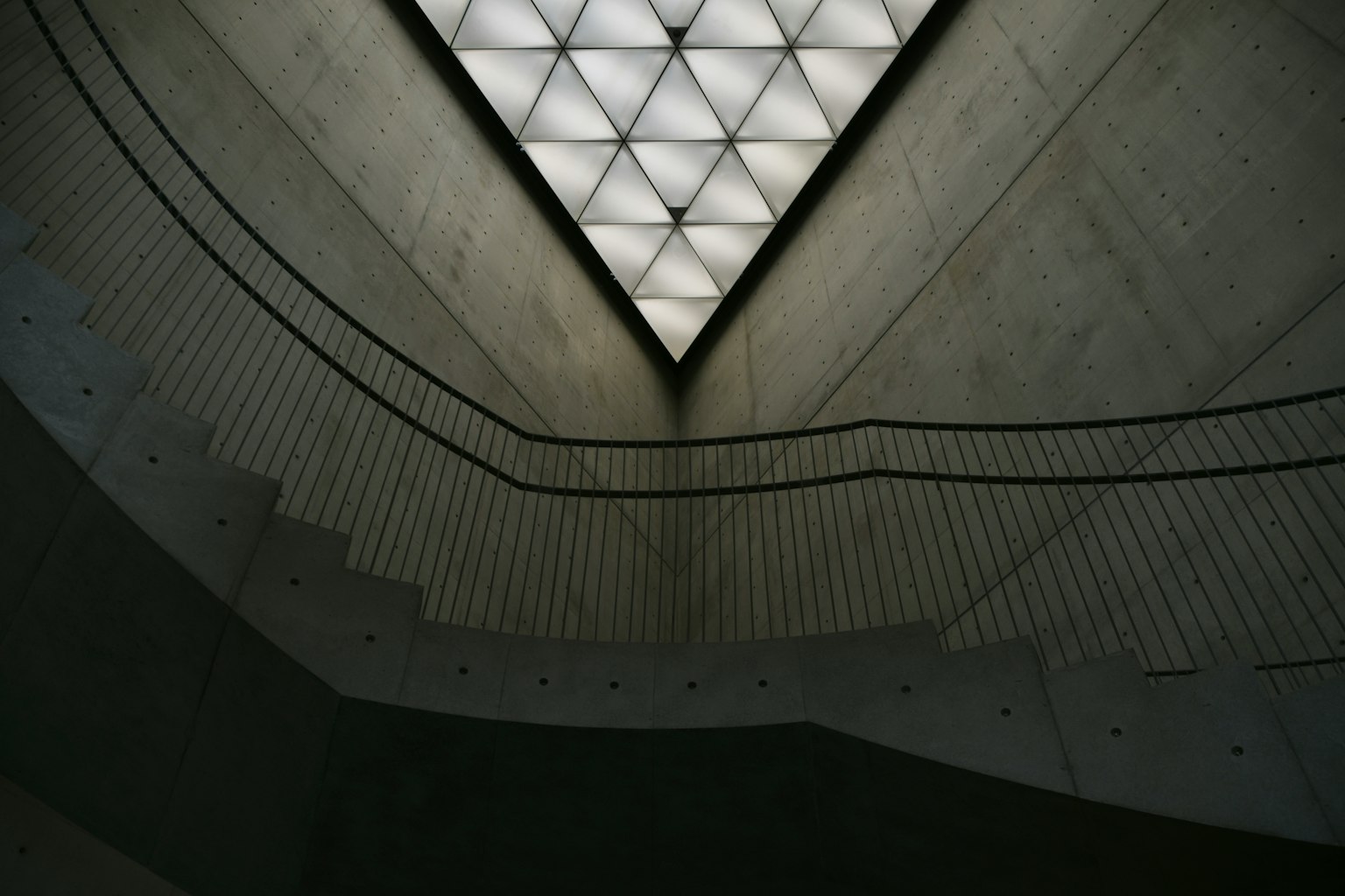 Concrete staircase with geometric ceiling design
