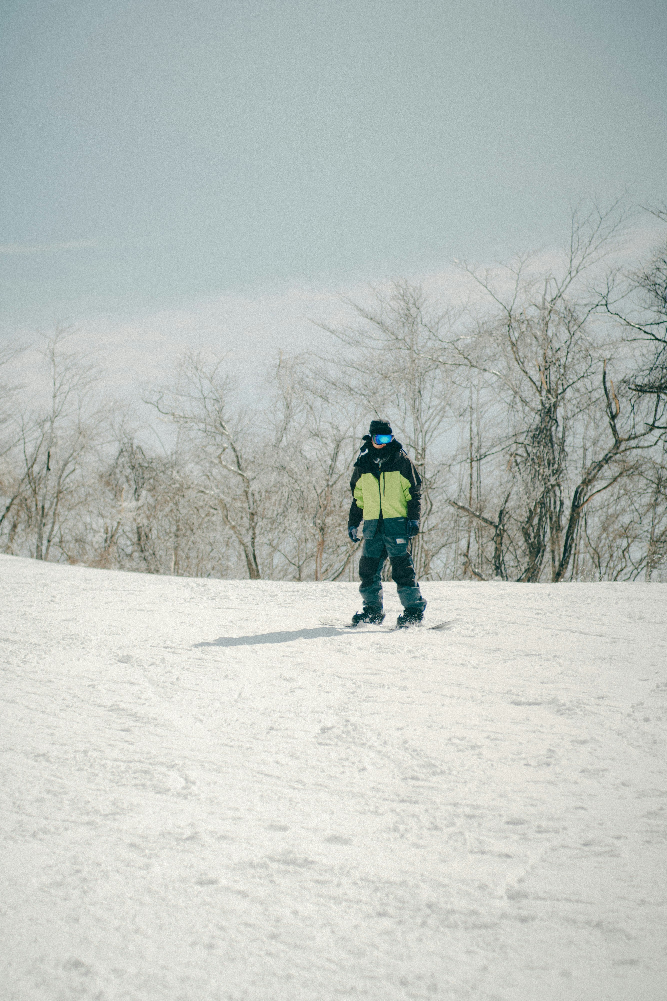 back view of a hiker walking on a snowy field