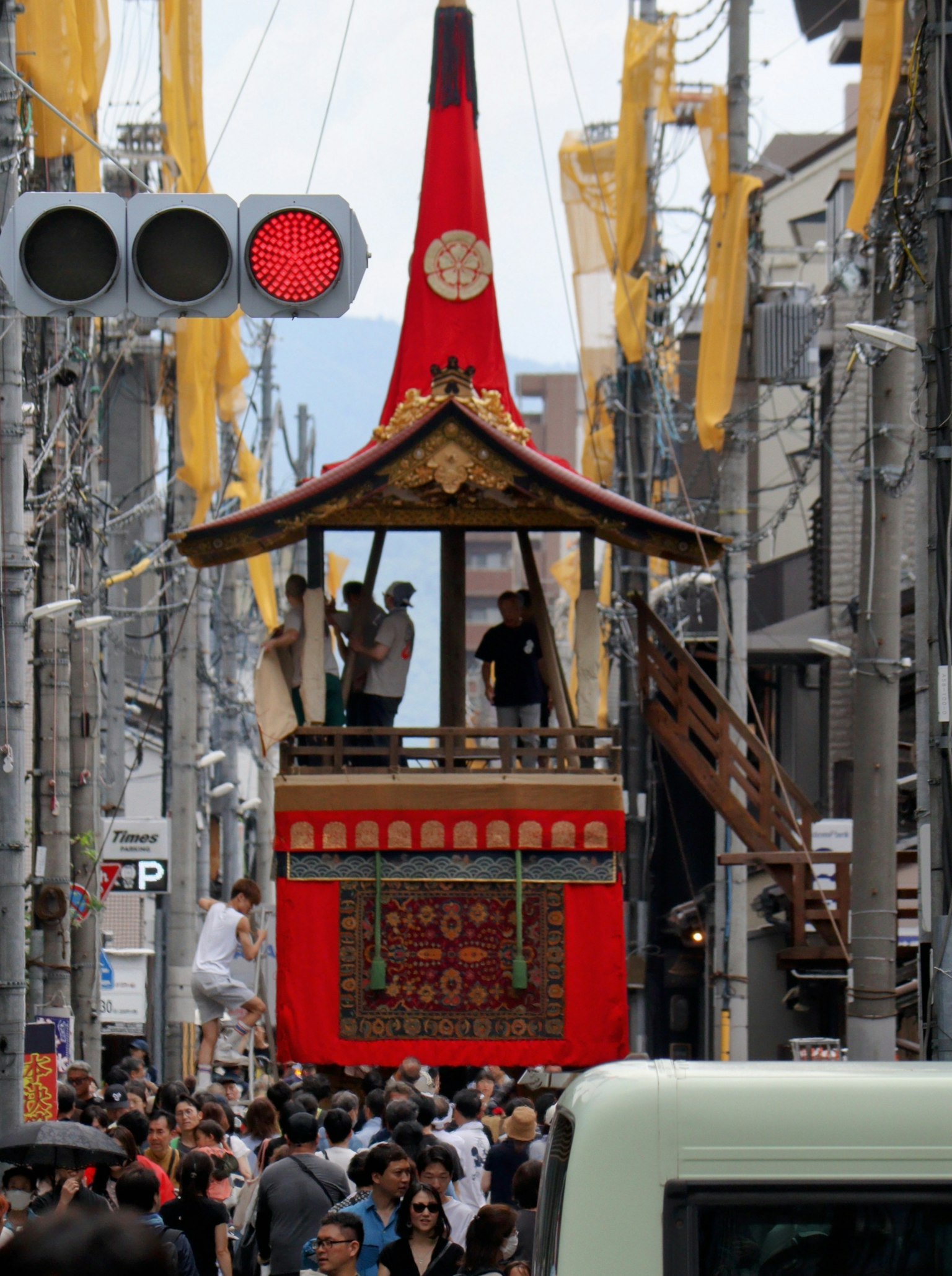 A festival float moving through a crowd of people