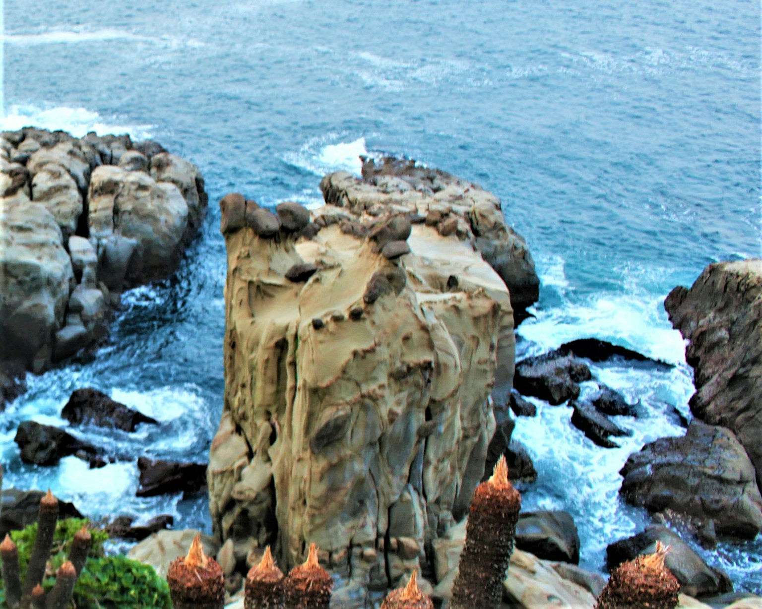 Beautiful landscape featuring rock formations surrounded by the sea and dynamic waves