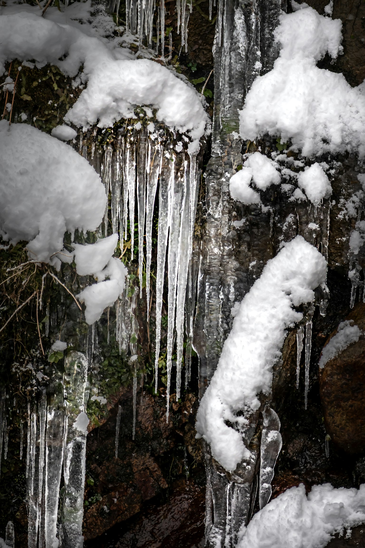 Close-up of icicles and snow-covered rocks