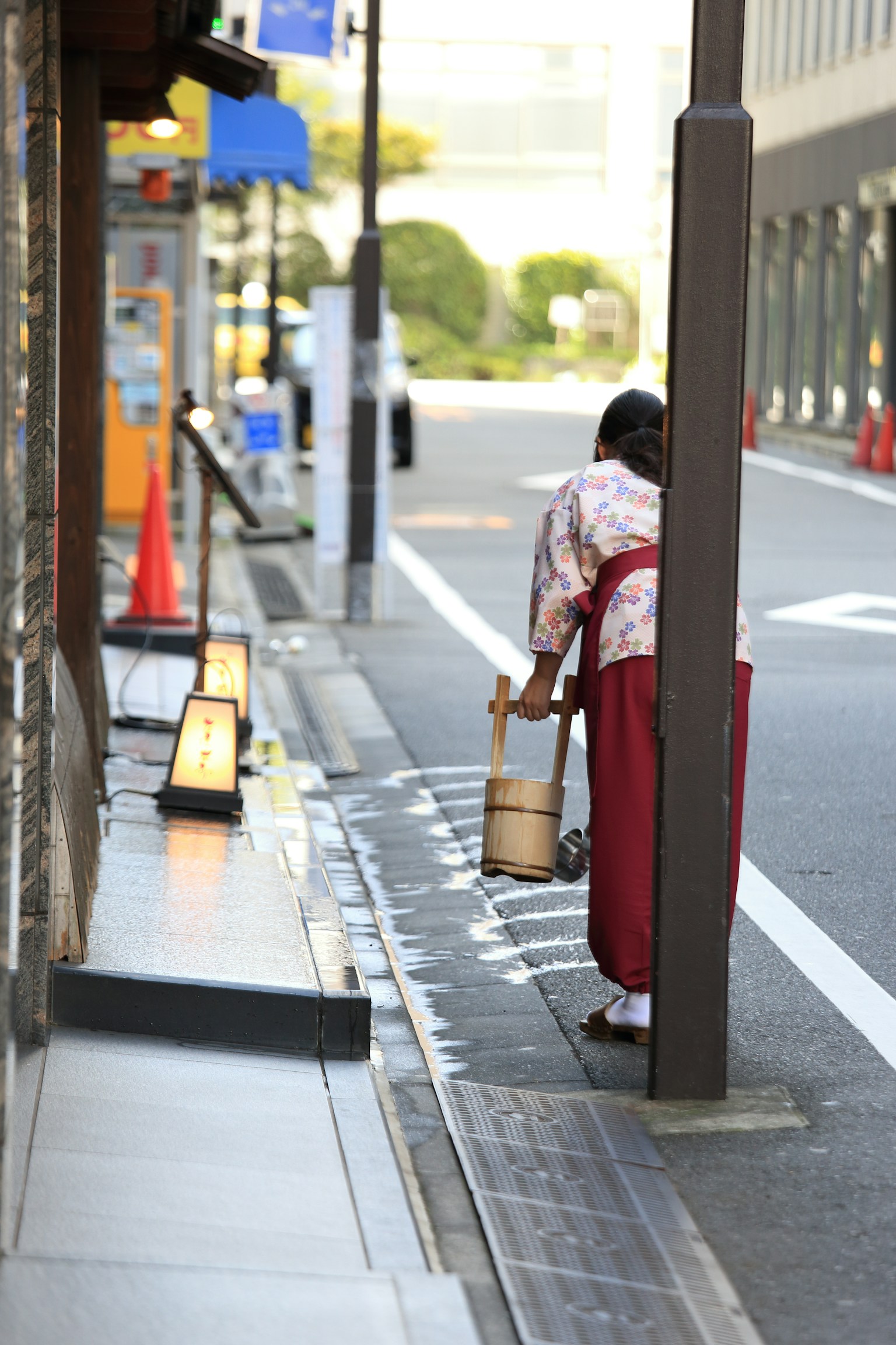A woman wearing a traditional kimono walking down the street