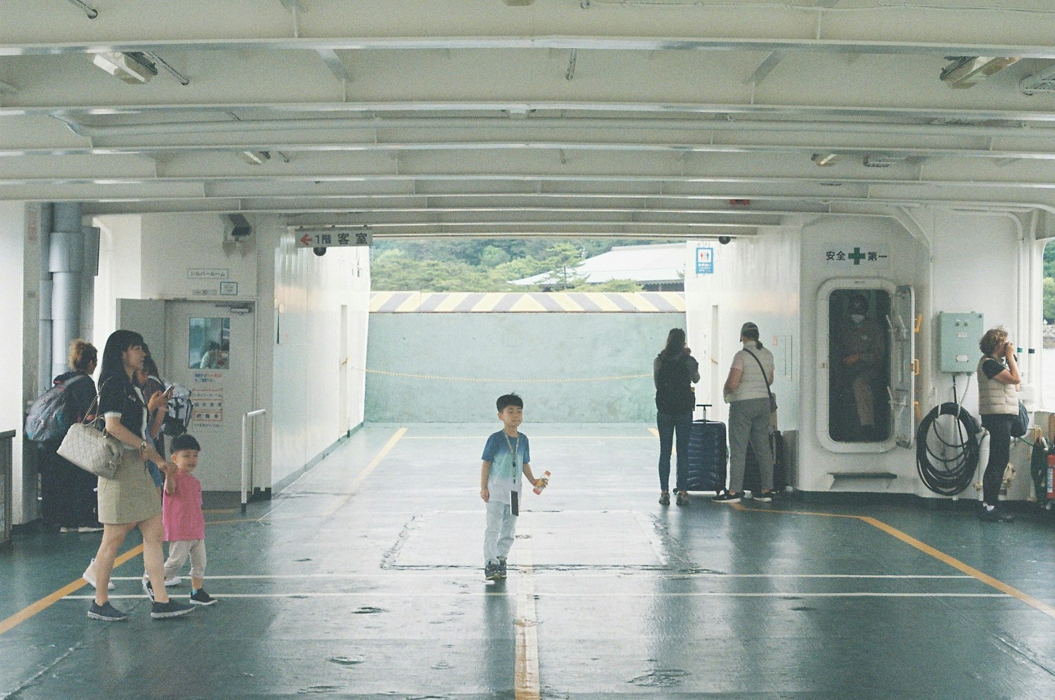 Scene of children and adults in a ferry interior