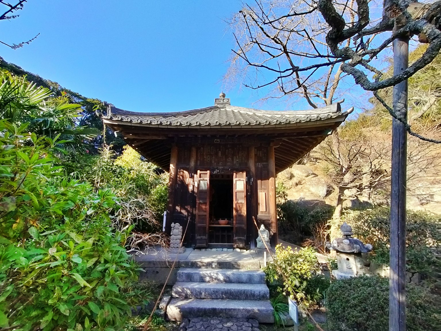 Traditional Japanese temple surrounded by greenery