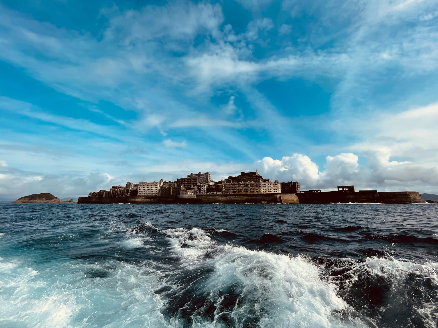 An abandoned island with ruins set against a blue sky