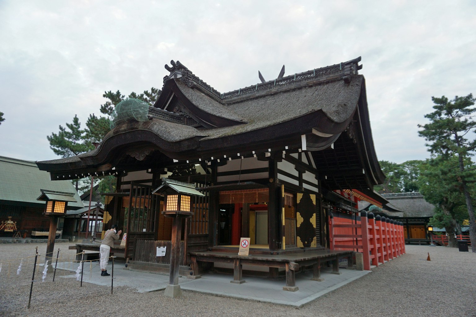 Traditional Japanese shrine building with surrounding landscape