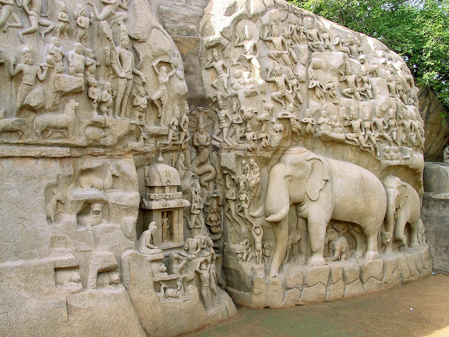 Carved stone wall featuring an elephant and ancient sculptures