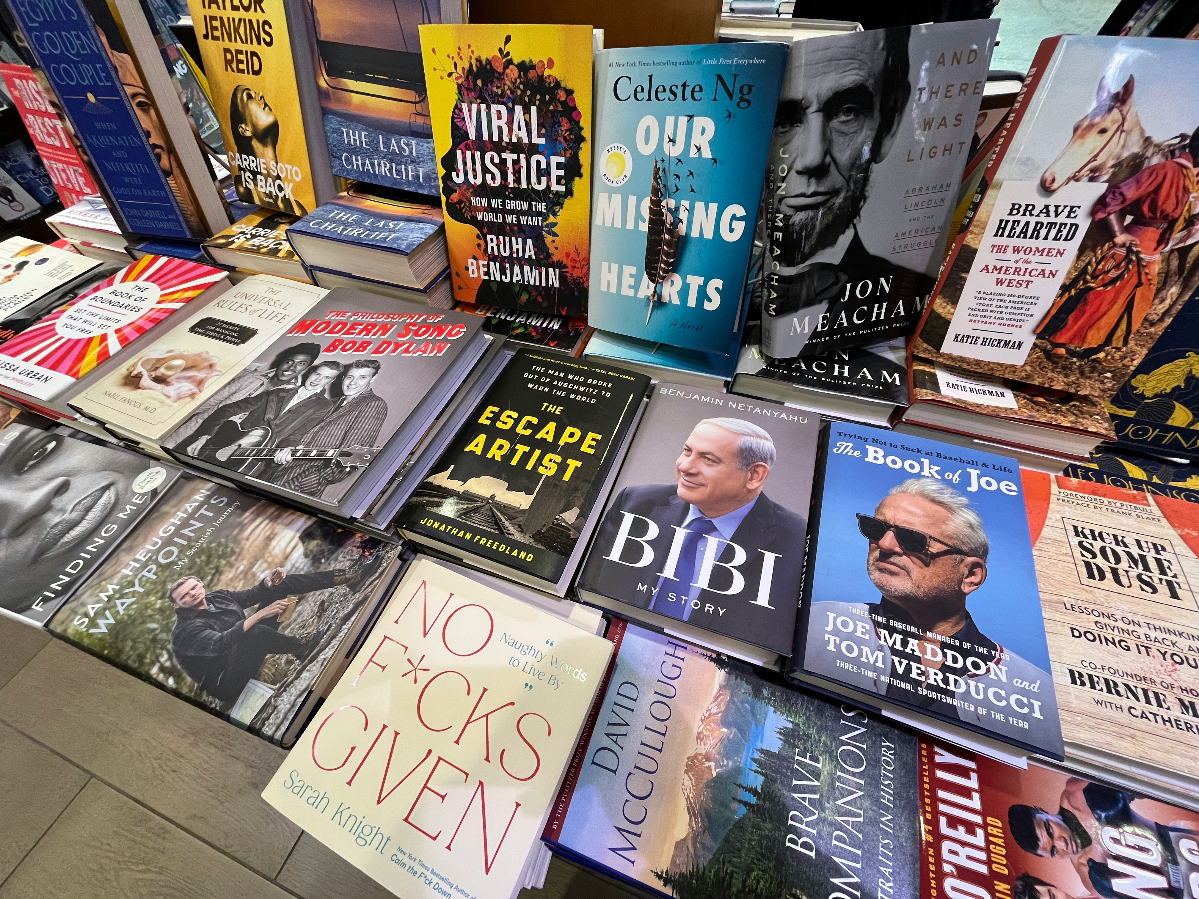 foreground of a bookstore shelf stacked with books