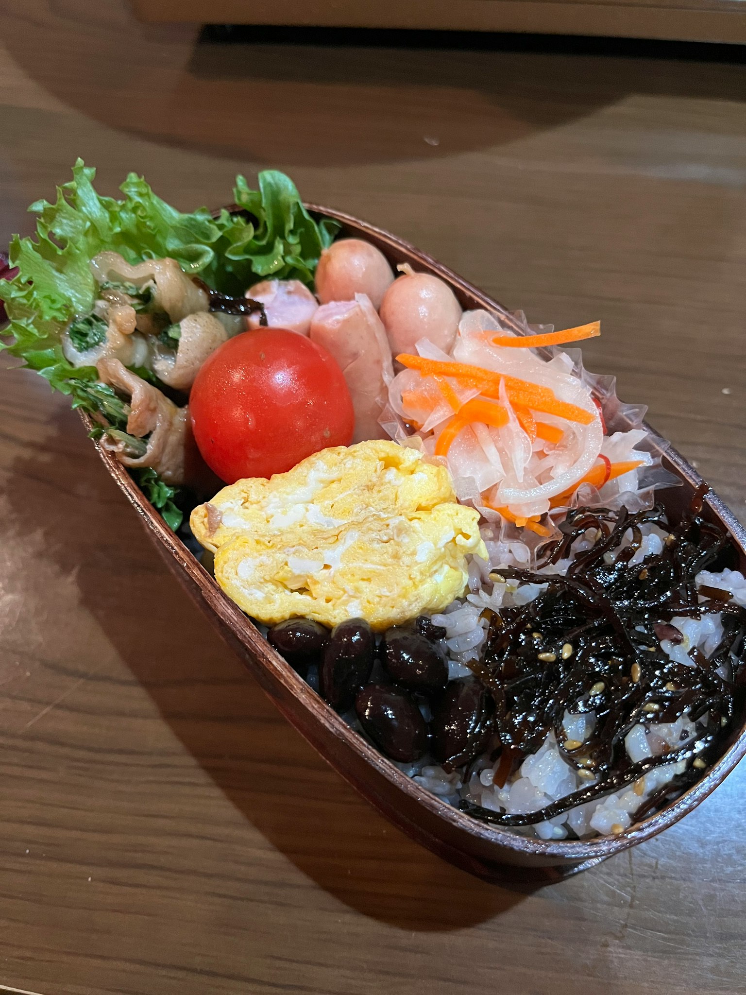 便當盒，米飯，海苔，炒蛋，蔬菜，櫻桃番茄和醃製胡蘿蔔