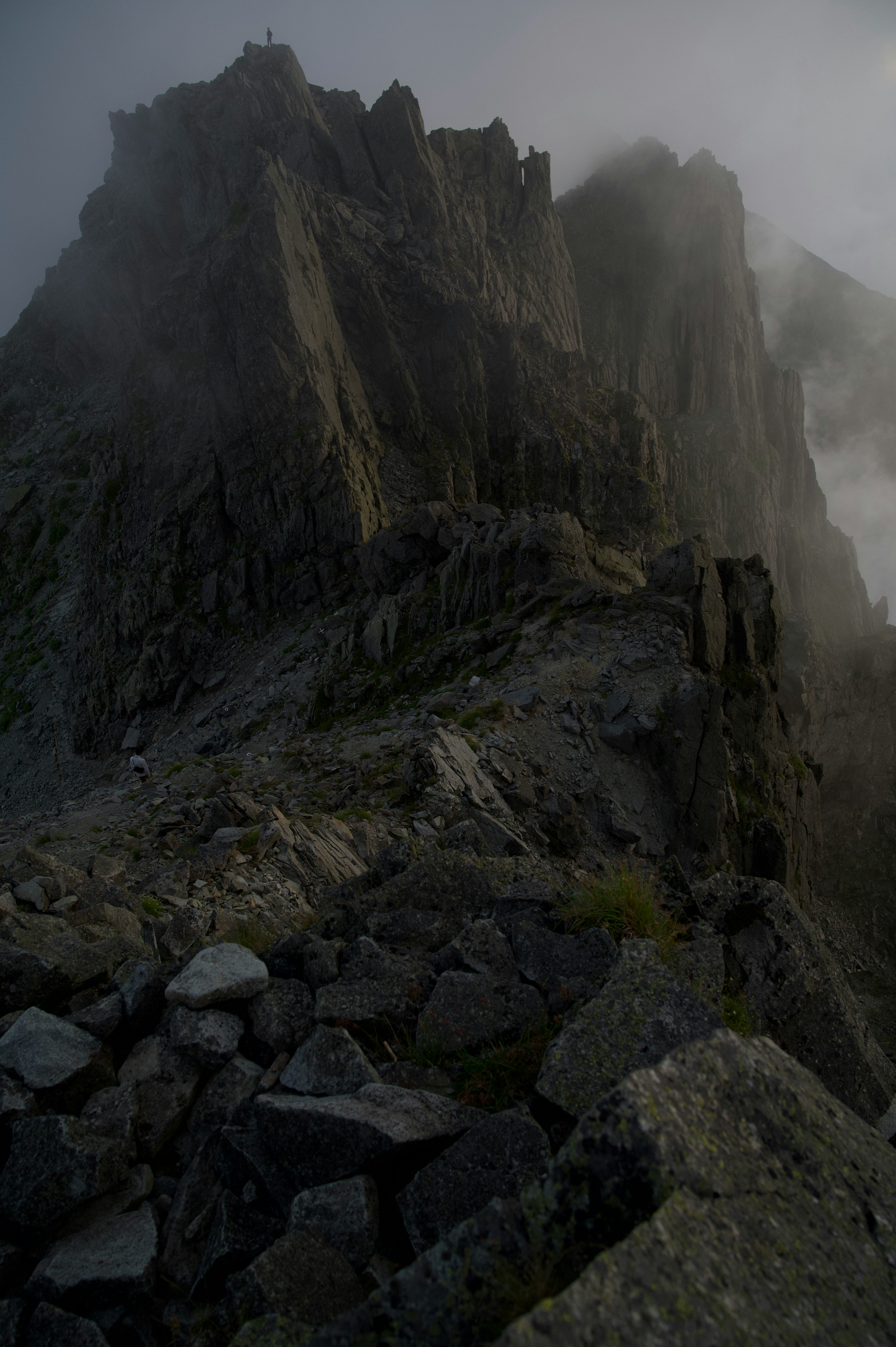 foggy rugged mountain ridge and rocky slope
