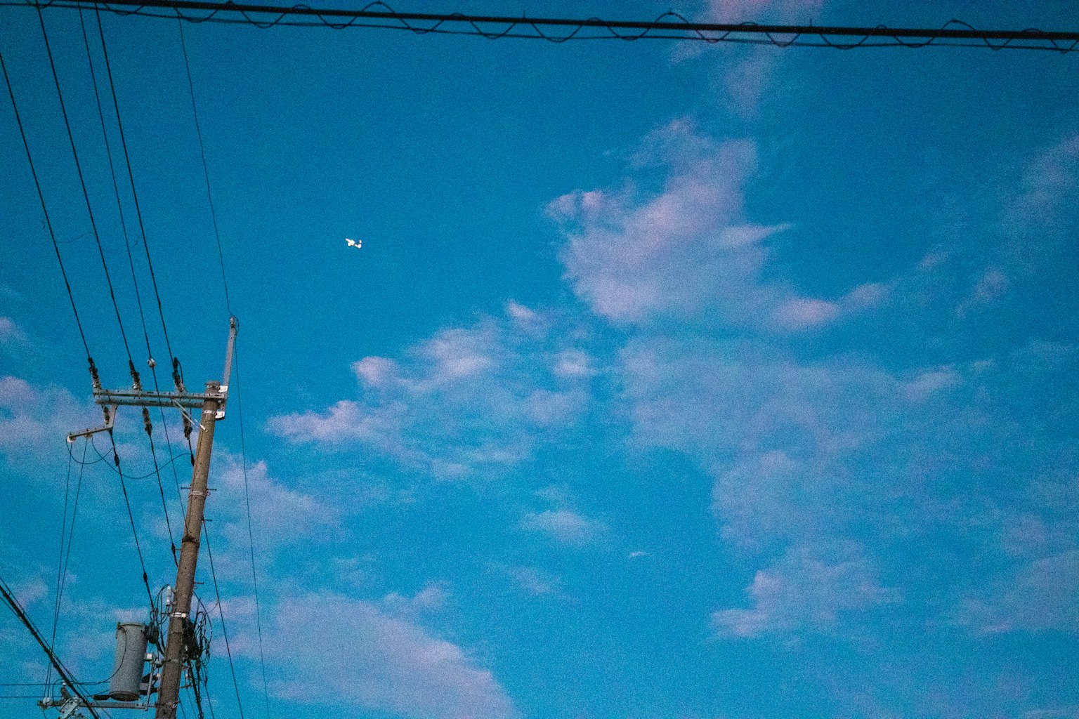 Blue sky with white clouds and power lines