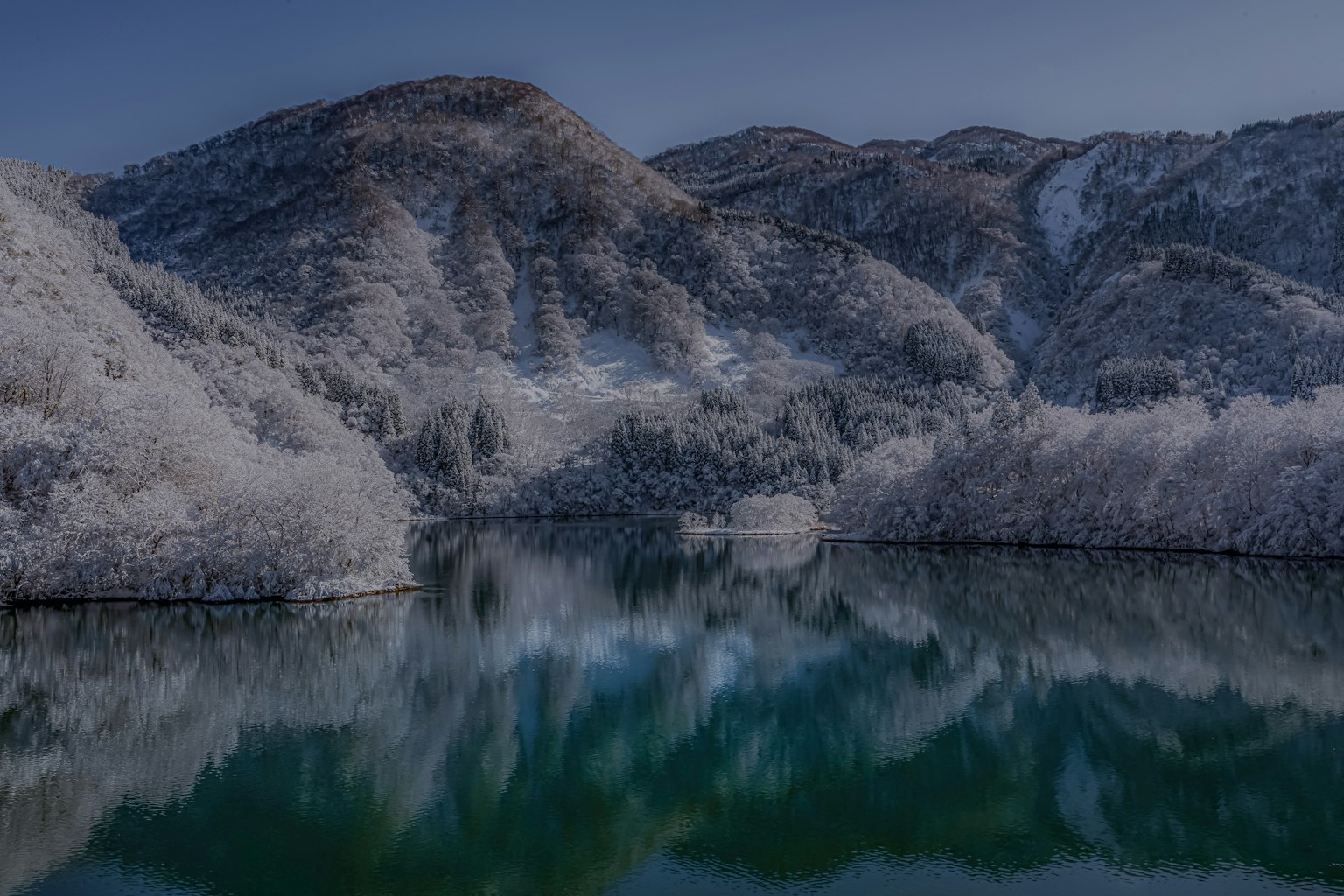 Snow-covered mountains and a tranquil lake landscape