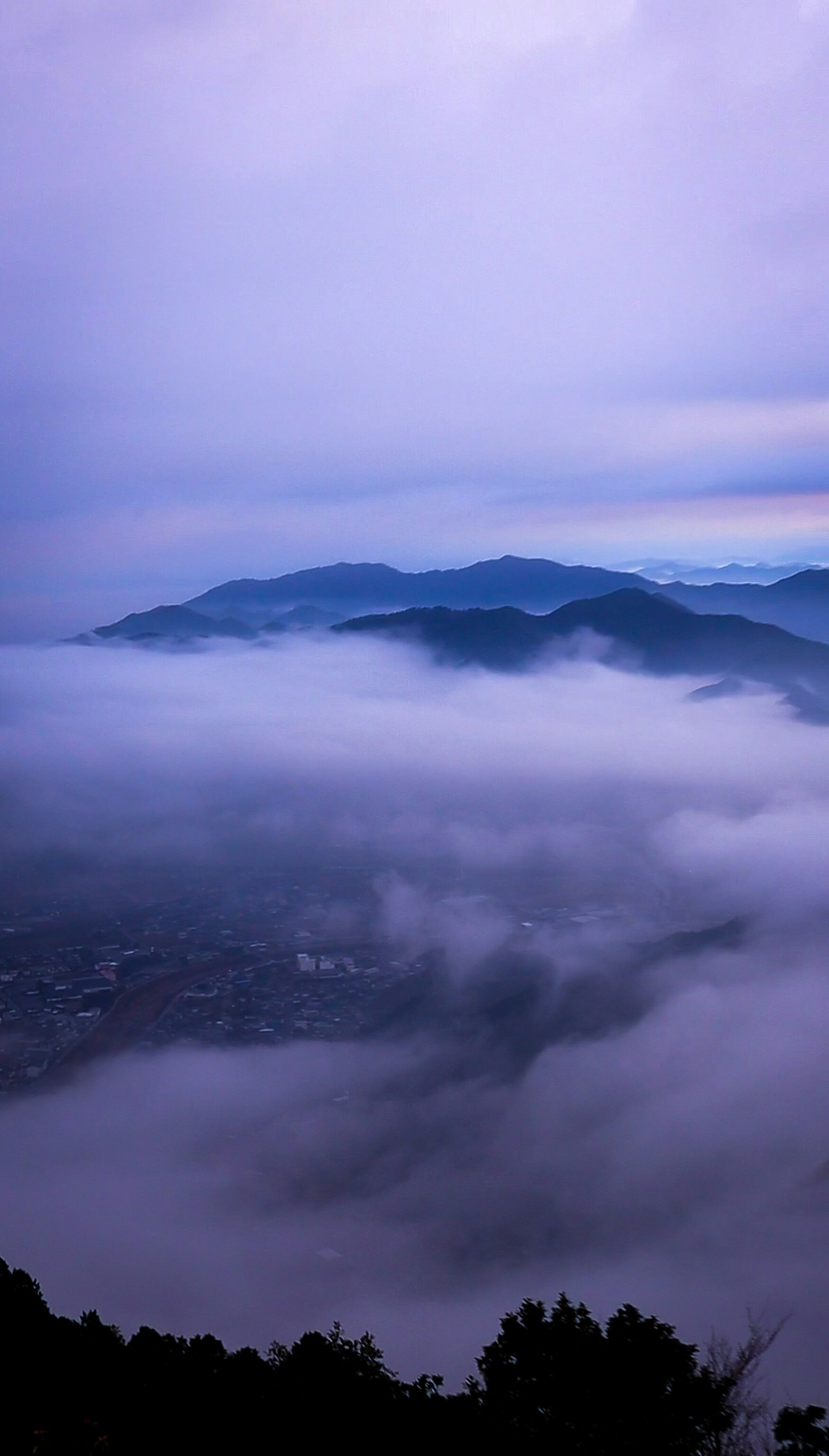 Landscape of mountains shrouded in blue mist