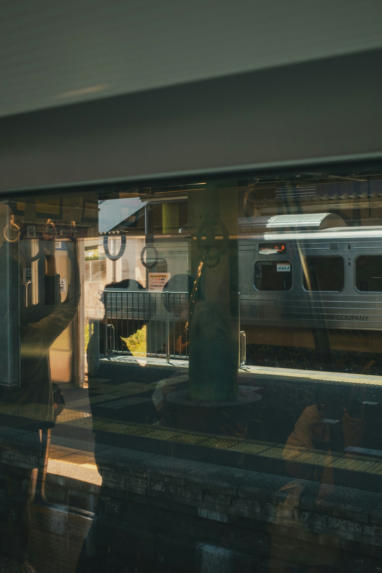View of a train station and train through a train window