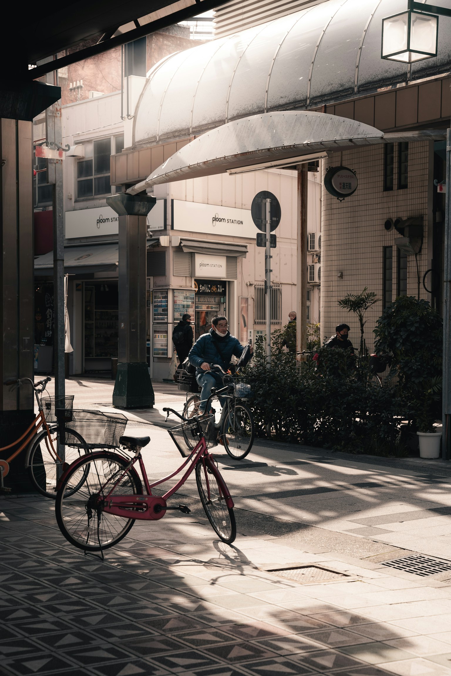 Scena di strada con biciclette sotto una luce soffusa persone che passano