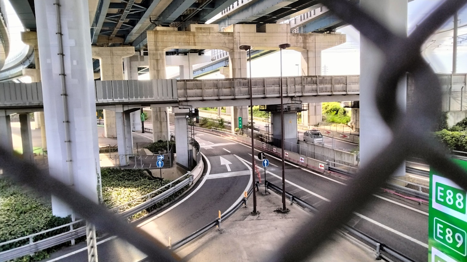Urban landscape featuring roads and signs beneath an overpass