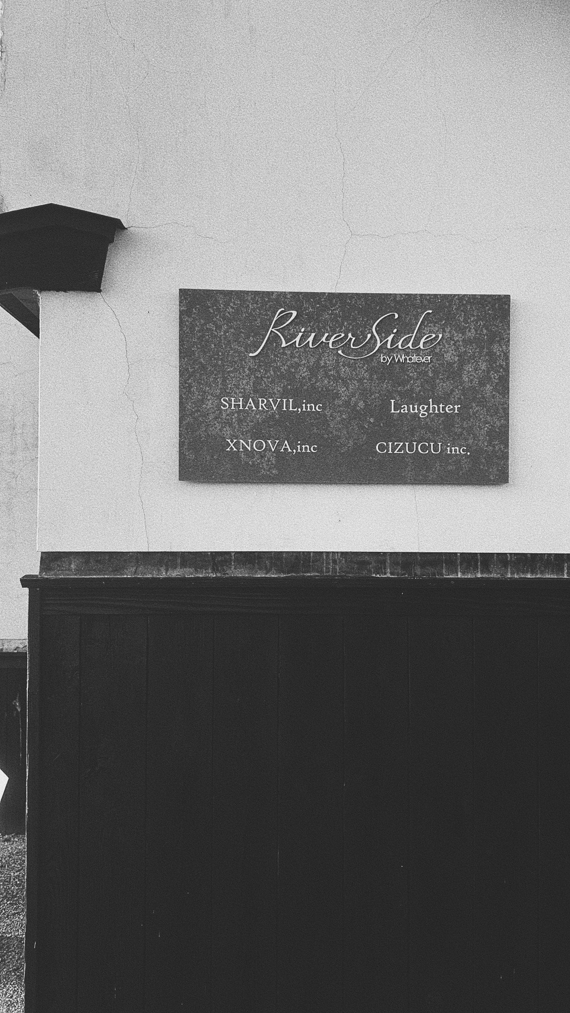 exterior wall with a “Riverside” sign