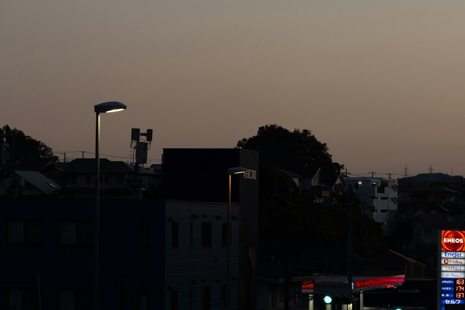 Silhouette of buildings at dusk with streetlight illumination