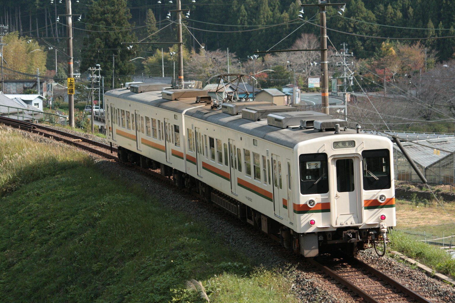 A white train running through a rural landscape