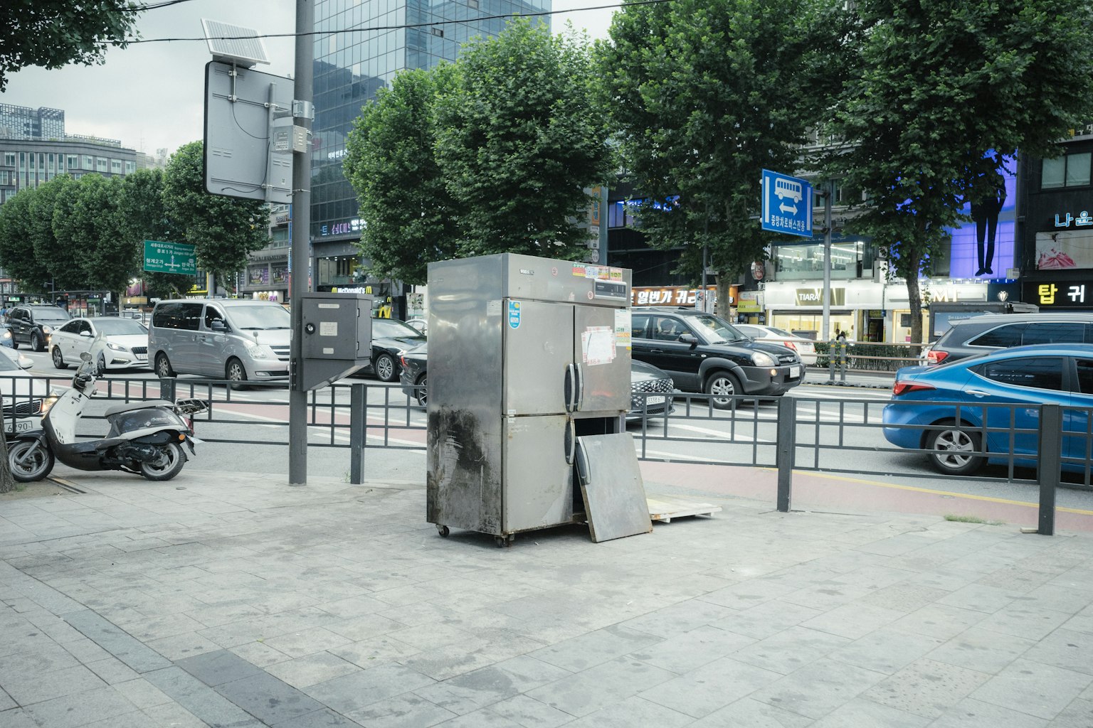 街角的旧金属自动售货机和周围的车辆