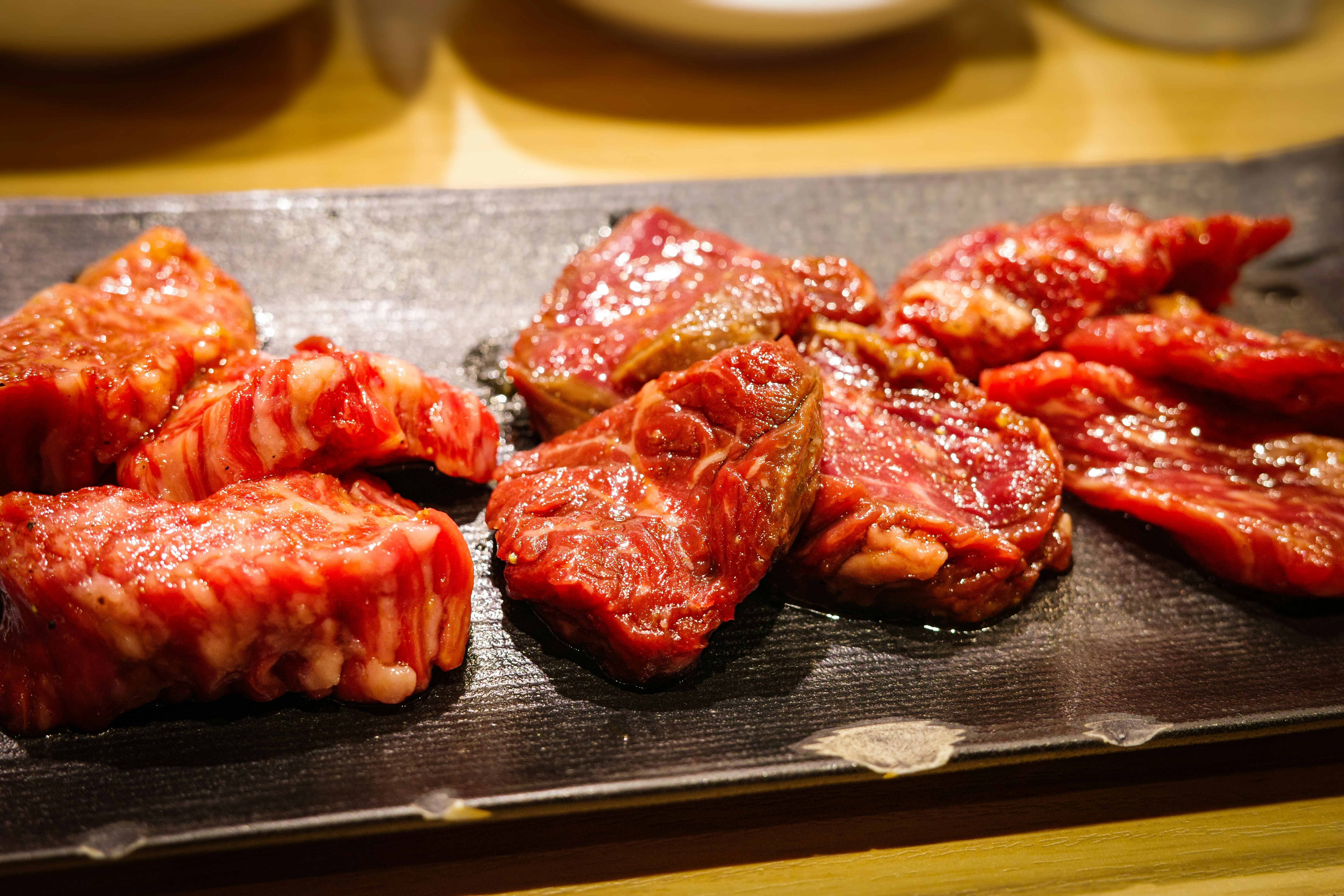 焼き肉の盛り合わせが鉄板の上で焼かれている