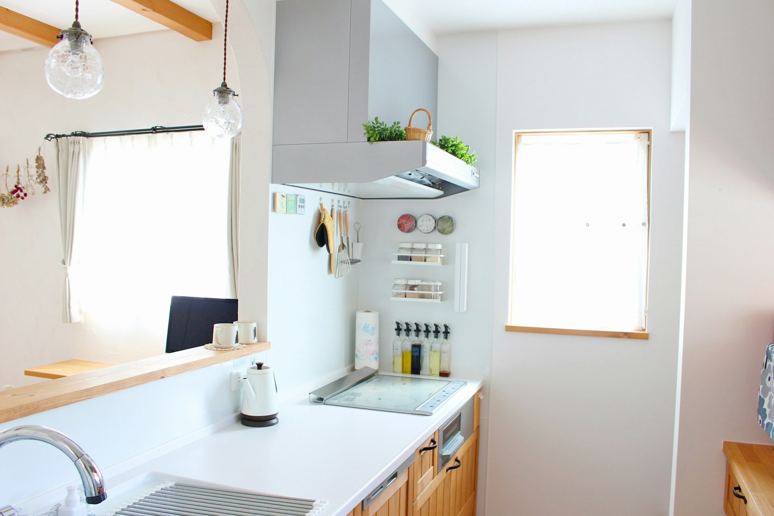 Bright kitchen with white countertop and wooden cabinetry
