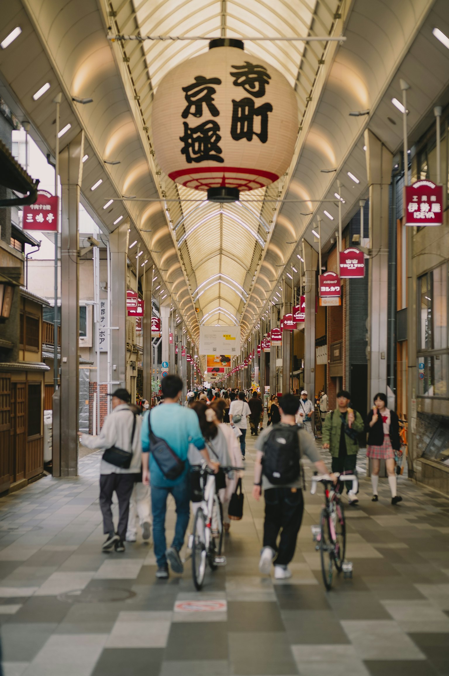 Busy shopping street with people walking and bicycles