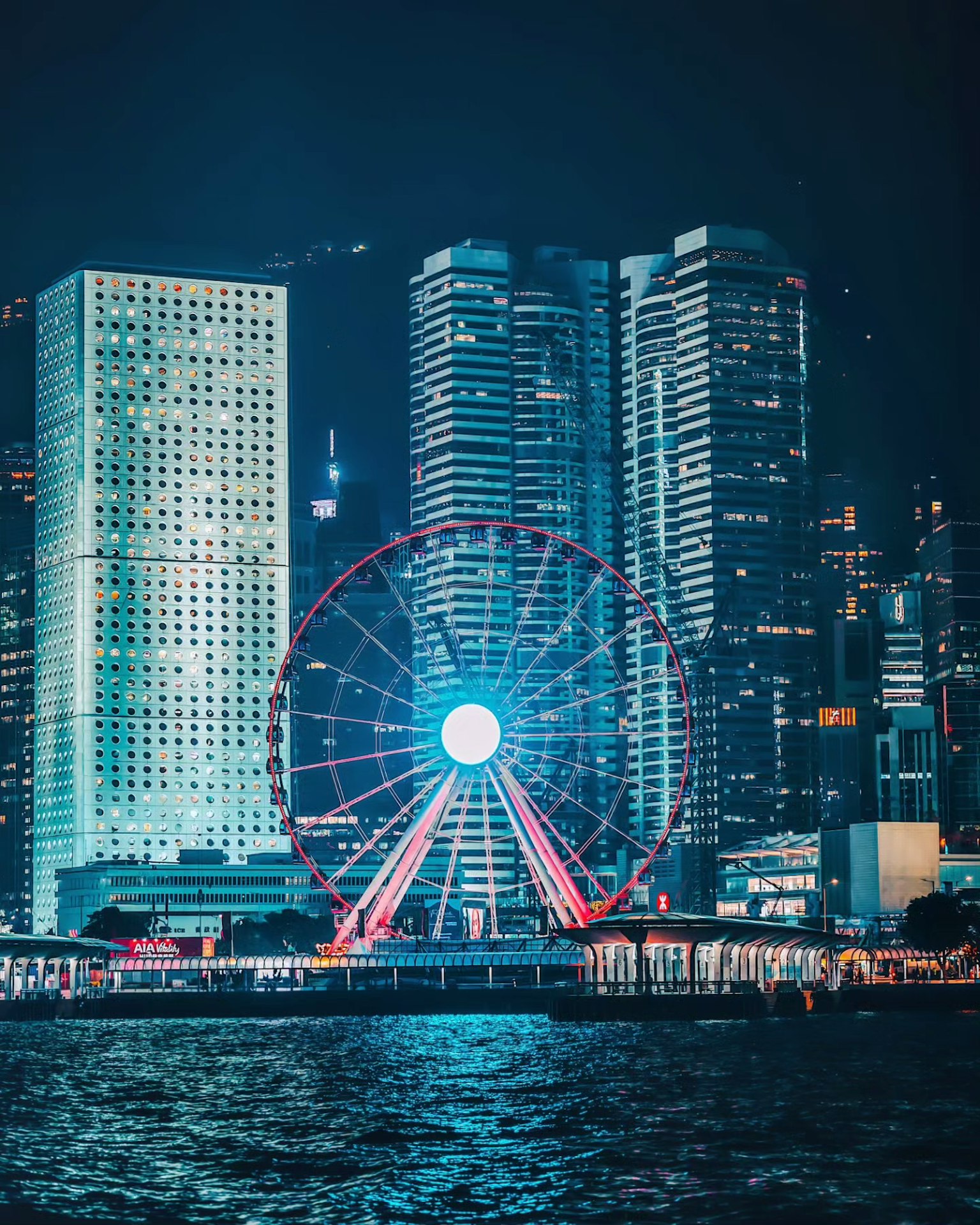 Beautiful night view of Hong Kong's Ferris wheel and skyscrapers