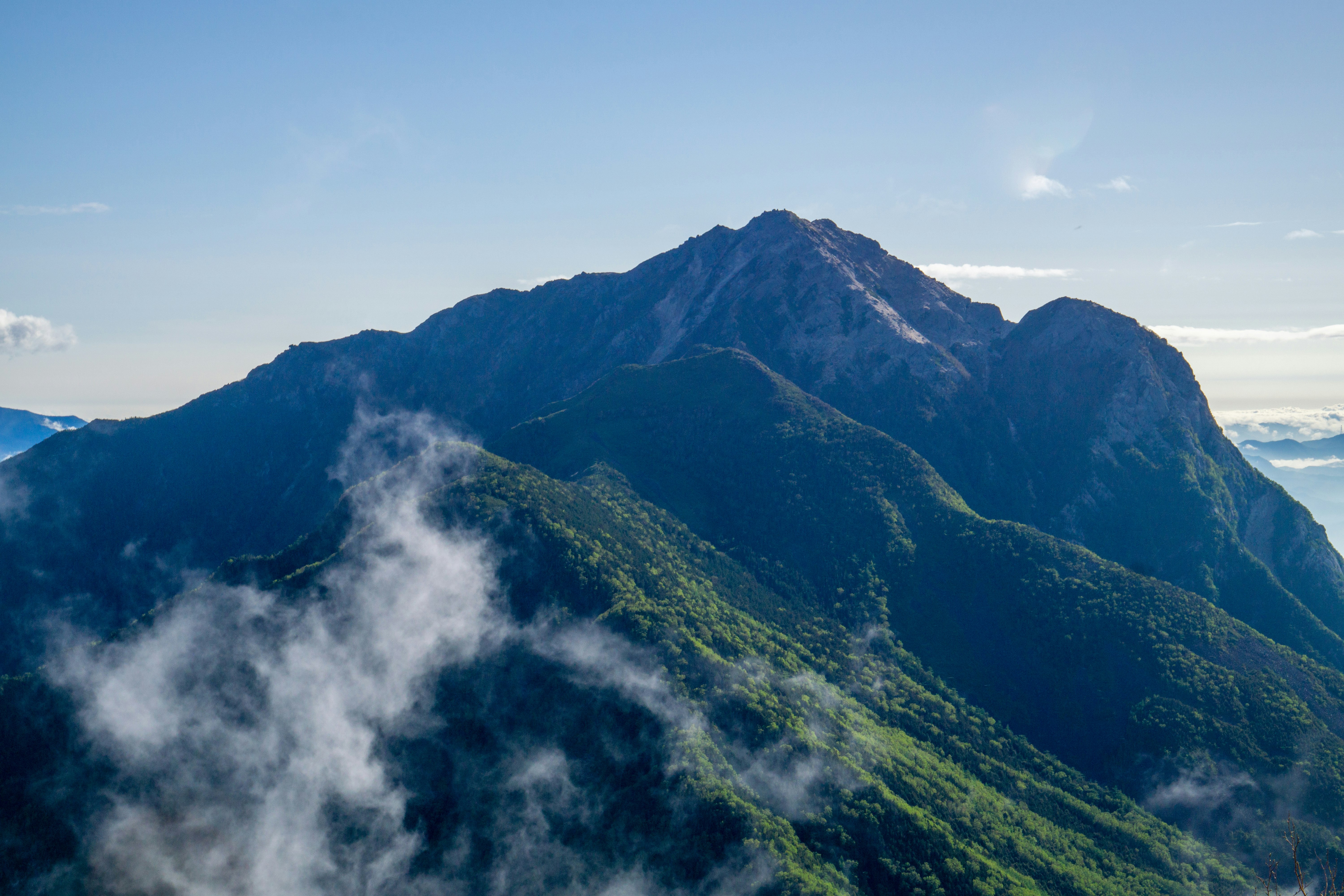 misty mountain ridges with lush green slopes
