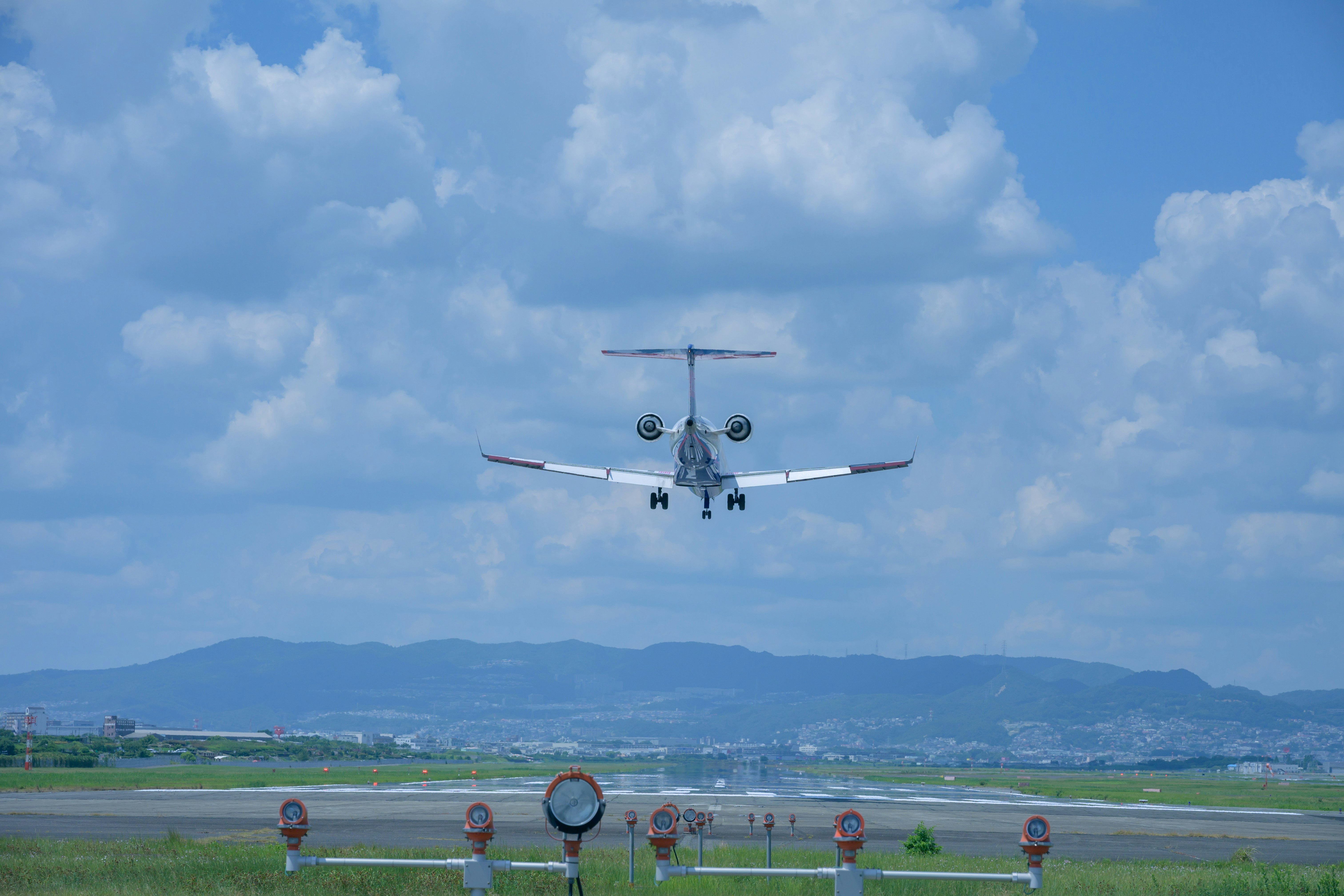 飛行機が着陸態勢で飛行する空港の滑走路と空