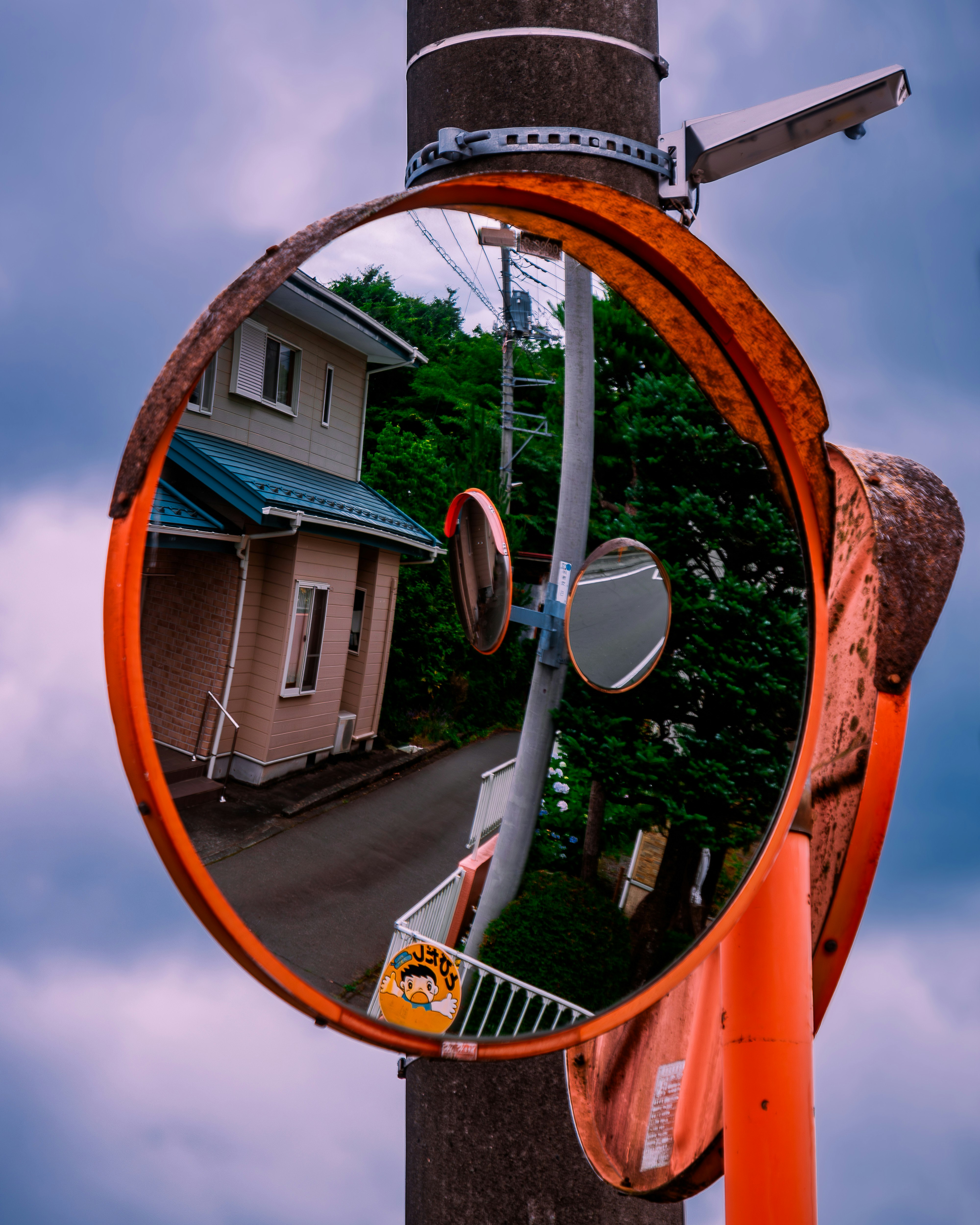 round security mirror reflecting a residential street