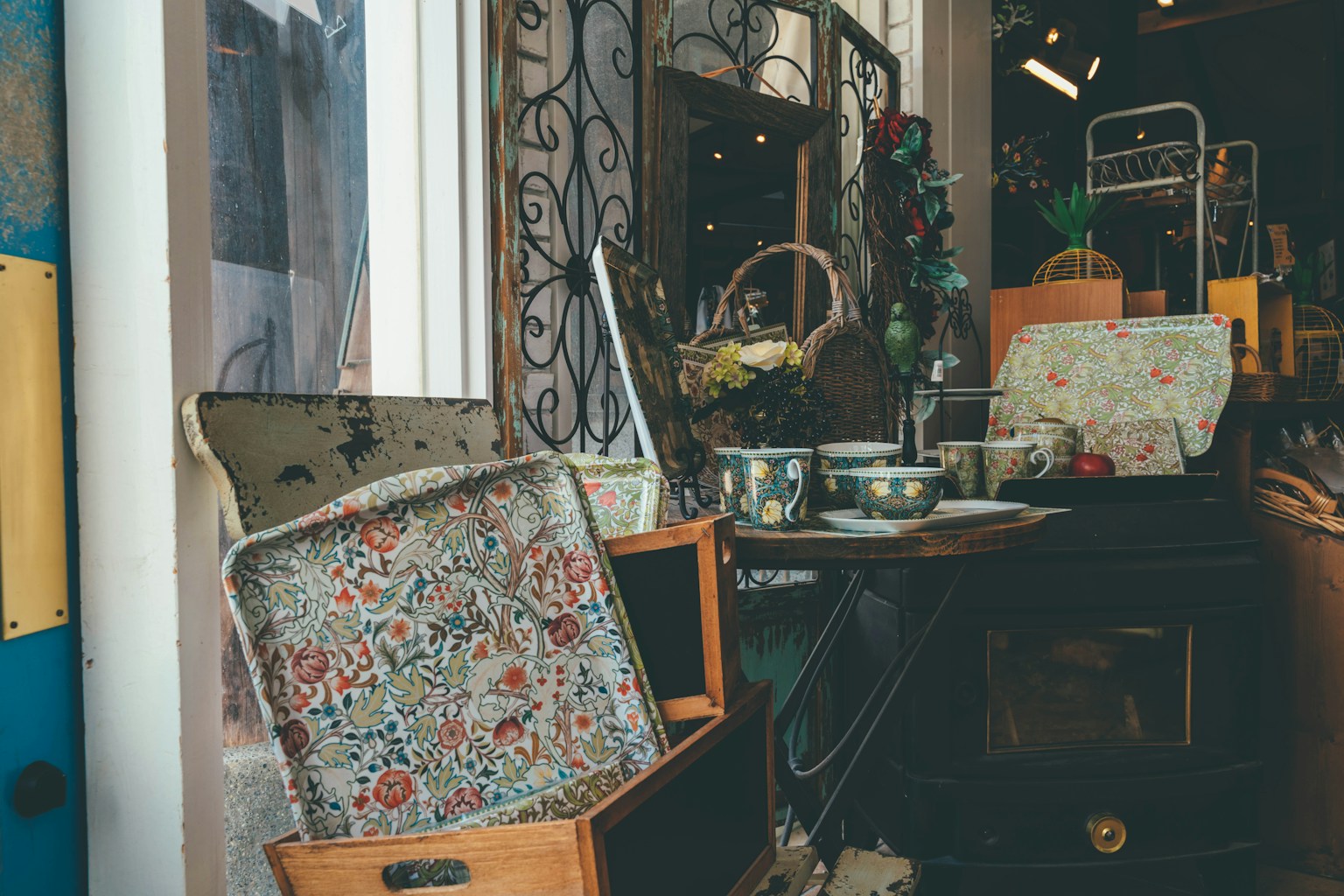 Entrance of an antique shop with vintage suitcases and dishware