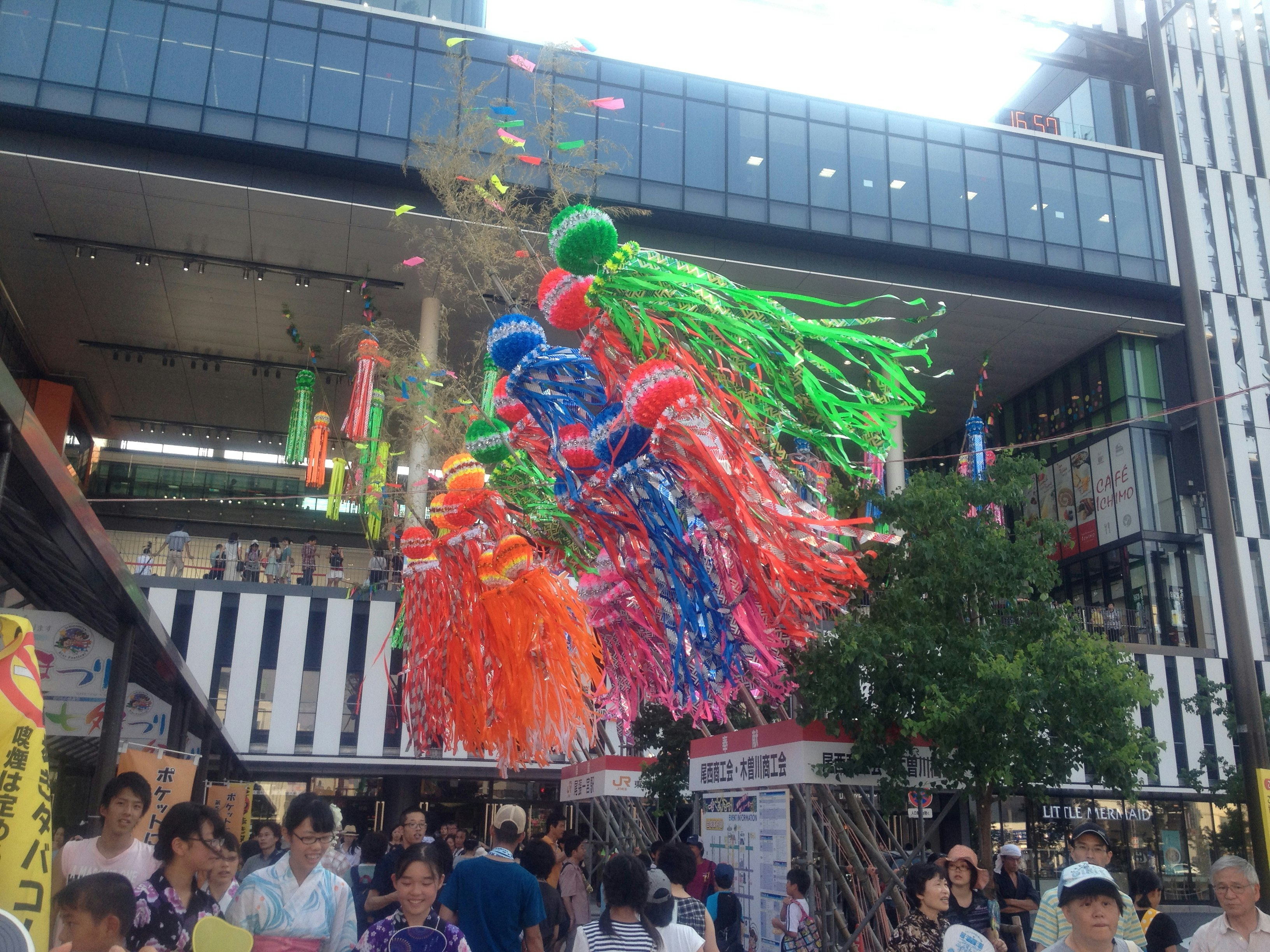 colorful Tanabata decorations hanging in a shopping arcade with people